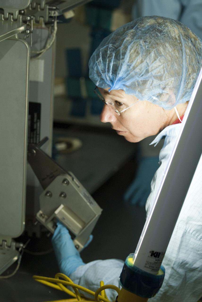 CAPE CANAVERAL, Fla. -- In the Space Station Processing Facility at NASA's Kennedy Space Center in Florida, STS-135 Mission Specialist Sandy Magnus, garbed in protective wear, inspects the Raffaello multi-purpose logistics module for shuttle Atlantis' flight to the International Space Station. Commander Chris Ferguson, Pilot Doug Hurley and Mission Specialists Sandra Magnus and Rex Walheim are targeted to launch on July 8, taking with them the Raffaello multi-purpose logistics module packed with supplies, logistics and spare parts. The STS-135 mission also will fly a system to investigate the potential for robotically refueling existing spacecraft and return a failed ammonia pump module to help NASA better understand the failure mechanism and improve pump designs for future systems. STS-135 will be the 33rd flight of Atlantis, the 37th shuttle mission to the space station, and the 135th and final mission of NASA's Space Shuttle Program. For more information visit, www.nasa.gov/mission_pages/shuttle/shuttlemissions/sts135/index.html. Photo credit: NASA/Kim Shiflett