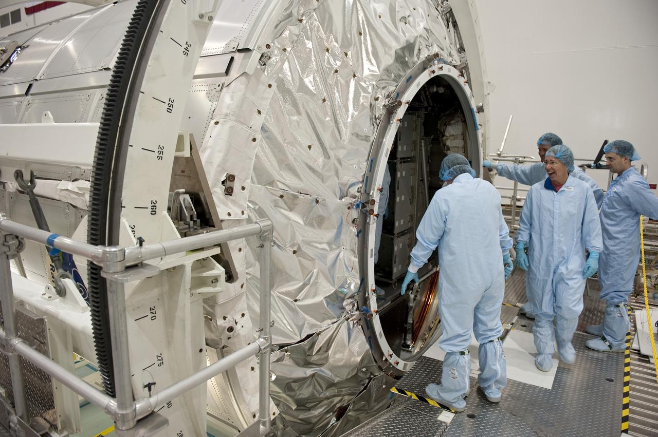 CAPE CANAVERAL, Fla. -- In the Space Station Processing Facility at NASA's Kennedy Space Center in Florida, STS-135 Mission Specialist Sandra Magnus and facility technicians garbed in protective wear, enjoy a light-hearted moment after inspecting the Raffaello multi-purpose logistics module for shuttle Atlantis' flight to the International Space Station. Commander Chris Ferguson, Pilot Doug Hurley and Mission Specialists Sandra Magnus and Rex Walheim are targeted to launch on July 8, taking with them the Raffaello multi-purpose logistics module packed with supplies, logistics and spare parts. The STS-135 mission also will fly a system to investigate the potential for robotically refueling existing spacecraft and return a failed ammonia pump module to help NASA better understand the failure mechanism and improve pump designs for future systems. STS-135 will be the 33rd flight of Atlantis, the 37th shuttle mission to the space station, and the 135th and final mission of NASA's Space Shuttle Program. For more information visit, www.nasa.gov/mission_pages/shuttle/shuttlemissions/sts135/index.html. Photo credit: NASA/Kim Shiflett
