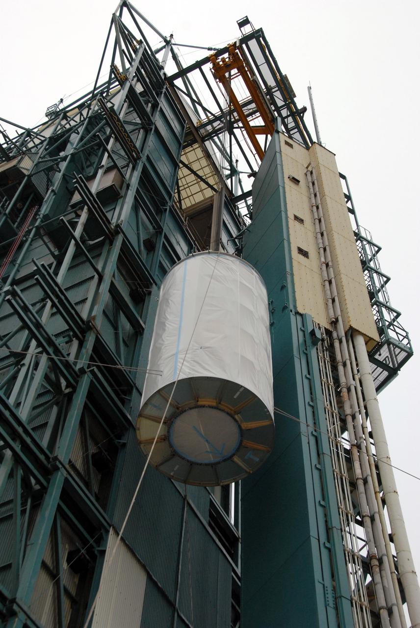 VANDENBERG AIR FORCE BASE, Calif. -- An overhead crane lifts the Aquarius/SAC-D spacecraft, secured inside its payload transportation canister, into the mobile service tower at NASA's Space Launch Complex-2 (SLC-2) at Vandenberg Air Force Base in California.       There, the spacecraft will be integrated to a United Launch Alliance Delta II rocket in preparation for the targeted June liftoff. Aquarius, the NASA-built instrument on the SAC-D spacecraft, will provide new insights into how variations in ocean surface salinity relate to fundamental climate processes on its three-year mission. Photo credit: NASA/VAFB