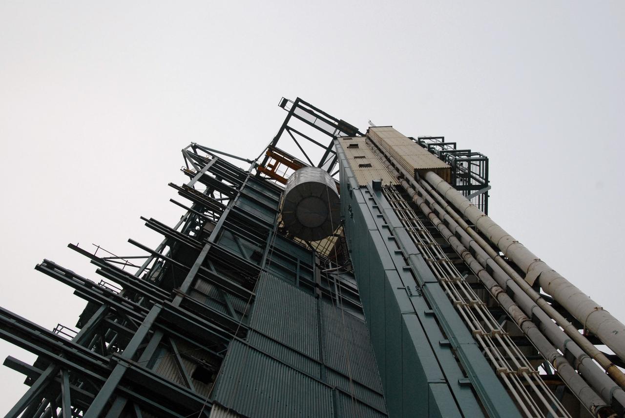 VANDENBERG AIR FORCE BASE, Calif. -- An overhead crane lifts the Aquarius/SAC-D spacecraft, secured inside its payload transportation canister, into the mobile service tower at NASA's Space Launch Complex-2 (SLC-2) at Vandenberg Air Force Base in California.       There, the spacecraft will be integrated to a United Launch Alliance Delta II rocket in preparation for the targeted June liftoff. Aquarius, the NASA-built instrument on the SAC-D spacecraft, will provide new insights into how variations in ocean surface salinity relate to fundamental climate processes on its three-year mission. Photo credit: NASA/VAFB