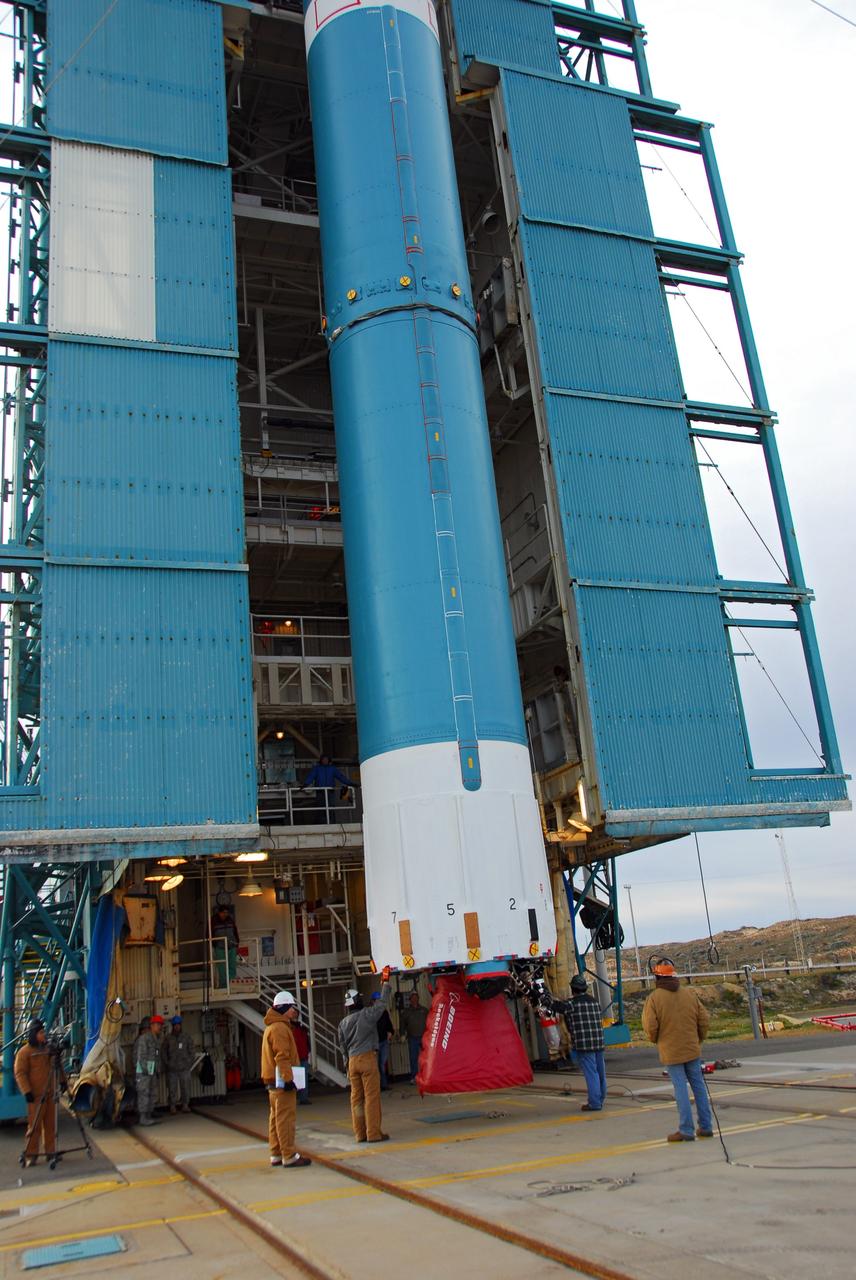 VANDENBERG AIR FORCE BASE, Calif. -- With the aid of an overhead crane, workers guide the first stage of the United Launch Alliance Delta II rocket that will carry the Aquarius/SAC-D spacecraft into low Earth orbit, into the service tower at NASA's Space Launch Complex-2 (SLC-2) at Vandenberg Air Force Base in California.             Following final tests, the spacecraft will be integrated to the Delta II in preparation for the targeted June launch. Aquarius, the NASA-built instrument on the SAC-D spacecraft, on its three-year mission, will provide new insights into how variations in ocean surface salinity relate to fundamental climate processes. Photo credit: NASA/VAFB