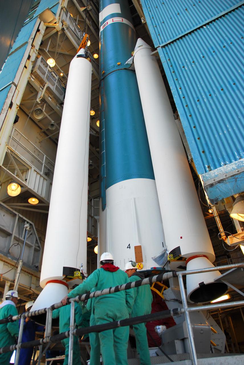 VANDENBERG AIR FORCE BASE, Calif. -- Workers attach one of three solid rocket motors to a United Launch Alliance Delta II launch vehicle in the service tower at NASA's Space Launch Complex-2 (SLC-2) at Vandenberg Air Force Base in California.       Following final tests, the spacecraft will be integrated to the Delta II in preparation for the targeted June launch. Aquarius, the NASA-built instrument on the SAC-D spacecraft will provide new insights into how variations in ocean surface salinity relate to fundamental climate processes on its three-year mission. Photo credit: NASA/VAFB