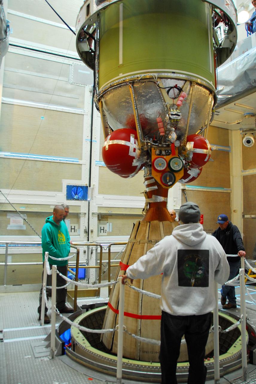 VANDENBERG AIR FORCE BASE, Calif. -- Workers using an overhead crane lower the  United Launch Alliance Delta II second stage motor toward the first stage for mating at NASA's Space Launch Complex-2 (SLC-2) at Vandenberg Air Force Base in California.          Following final tests, the Aquarius/SAC-D spacecraft will be integrated to the Delta II launch vehicle in preparation for the targeted June liftoff. Aquarius, the NASA-built instrument on the SAC-D spacecraft will provide new insights into how variations in ocean surface salinity relate to fundamental climate processes on its three-year mission. Photo credit: NASA/VAFB