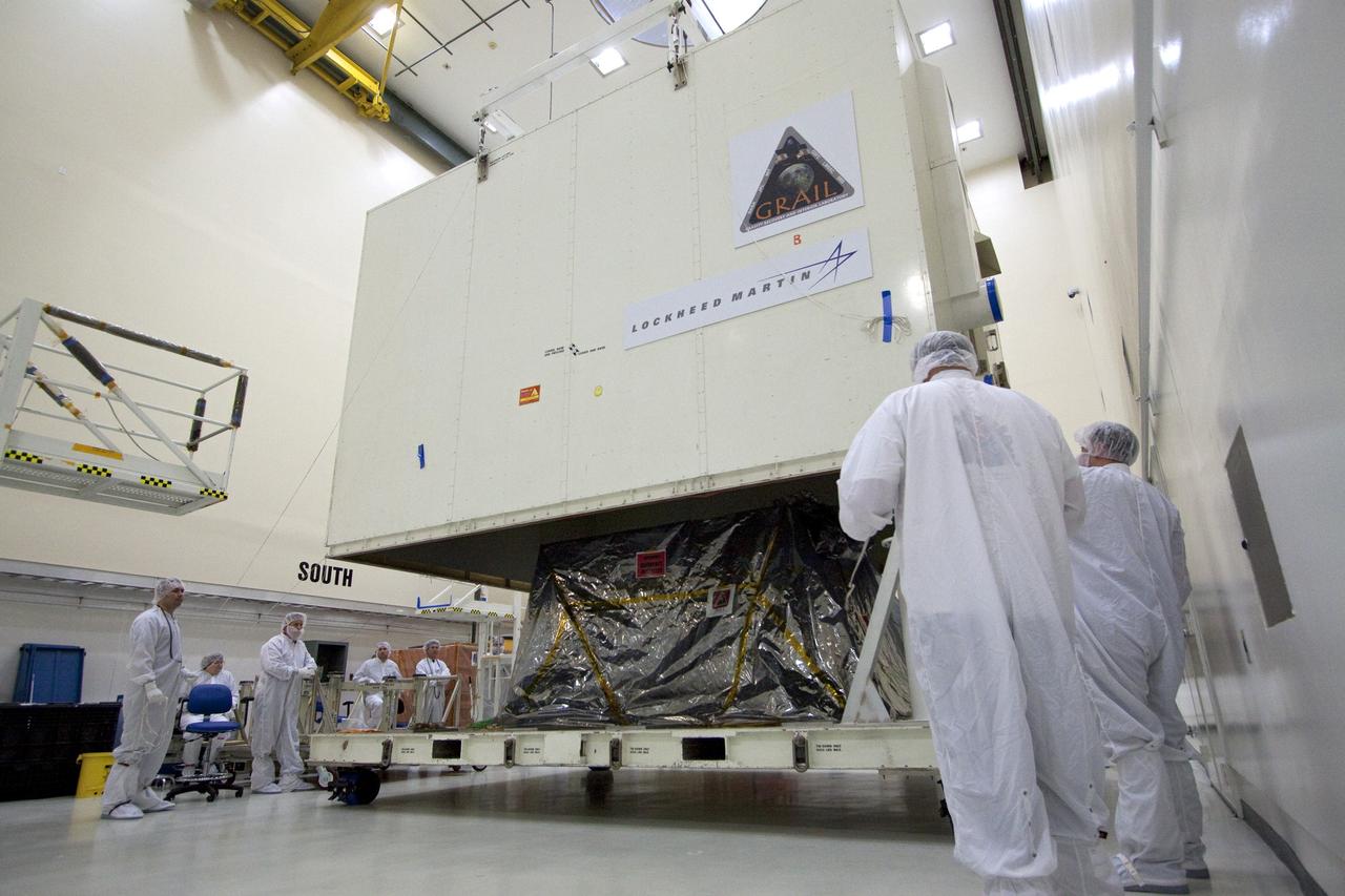 CAPE CANAVERAL, Fla. -- Technicians in the Astrotech payload processing facility in Titusville, Fla., unpack NASA's Gravity Recovery and Interior Laboratory, or GRAIL, twin spacecraft for testing and processing. GRAIL was built at the Lockheed Martin plant in Denver, Colo. The United Launch Alliance Delta II rocket that will carry GRAIL into lunar orbit already is fully stacked at NASA's Space Launch Complex 17B and launch is scheduled for Sept. 8.              The GRAIL mission is a part of NASA's Discovery Program. GRAIL will fly twin spacecraft in tandem orbits around the moon for several months to measure its gravity field. The mission also will answer longstanding questions about Earth's moon and provide scientists a better understanding of how Earth and other rocky planets in the solar system formed. For more information, visit http://science.nasa.gov/missions/grail/. Photo credit: NASA/Jack Pfaller