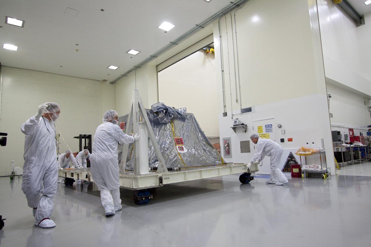 CAPE CANAVERAL, Fla. -- Technicians in the Astrotech payload processing facility in Titusville, Fla., roll NASA's Gravity Recovery and Interior Laboratory, or GRAIL, twin spacecraft toward a test stand where they will be processed for launch. GRAIL was built at the Lockheed Martin plant in Denver, Colo. The United Launch Alliance Delta II rocket that will carry GRAIL into lunar orbit already is fully stacked at NASA's Space Launch Complex 17B and launch is scheduled for Sept. 8.            The GRAIL mission is a part of NASA's Discovery Program. GRAIL will fly twin spacecraft in tandem orbits around the moon for several months to measure its gravity field. The mission also will answer longstanding questions about Earth's moon and provide scientists a better understanding of how Earth and other rocky planets in the solar system formed. For more information, visit http://science.nasa.gov/missions/grail/. Photo credit: NASA/Jack Pfaller