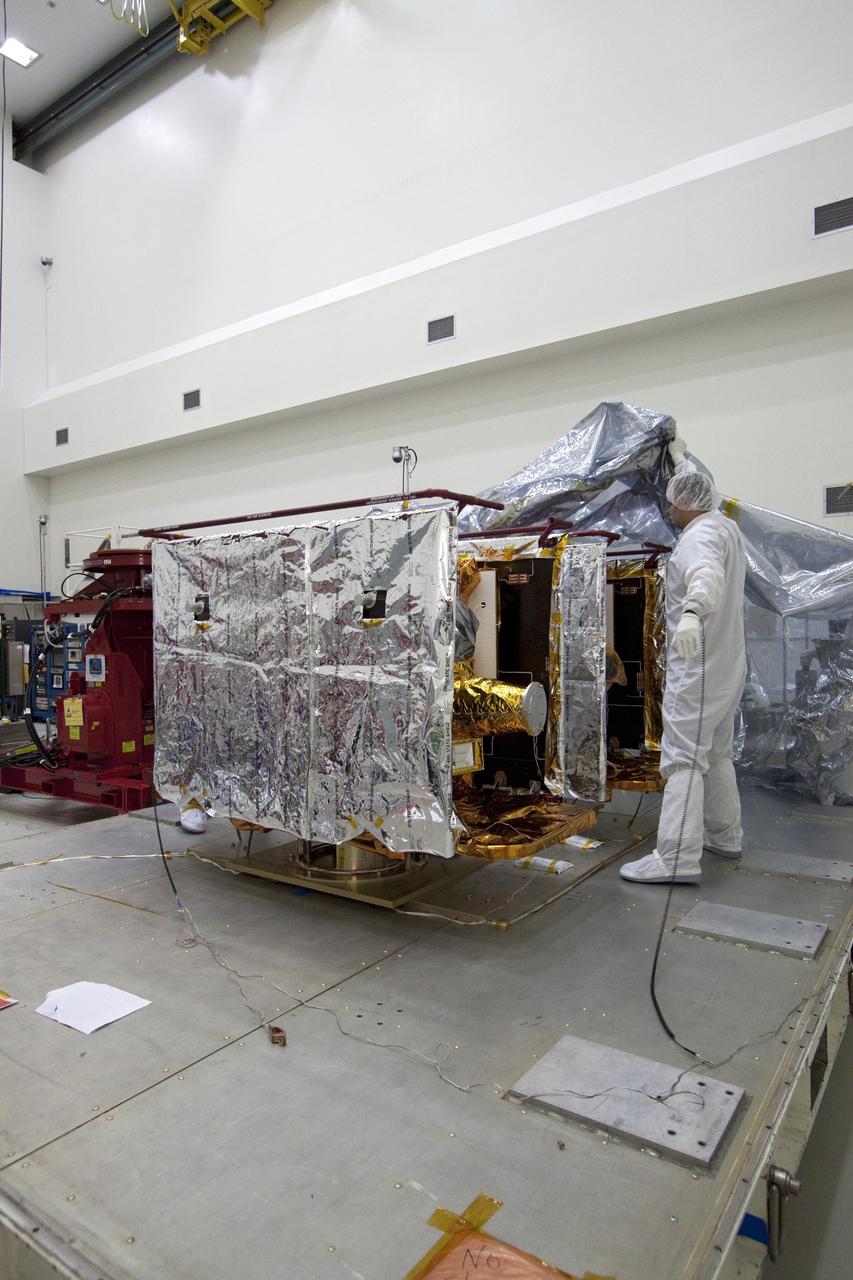 CAPE CANAVERAL, Fla. -- Technicians in the Astrotech payload processing facility in Titusville, Fla., remove the protective cover from NASA's Gravity Recovery and Interior Laboratory, or GRAIL, twin spacecraft to begin testing and processing. GRAIL was built at the Lockheed Martin plant in Denver, Colo. The United Launch Alliance Delta II rocket that will carry GRAIL into lunar orbit already is fully stacked at NASA's Space Launch Complex 17B and launch is scheduled for Sept. 8.              The GRAIL mission is a part of NASA's Discovery Program. GRAIL will fly twin spacecraft in tandem orbits around the moon for several months to measure its gravity field. The mission also will answer longstanding questions about Earth's moon and provide scientists a better understanding of how Earth and other rocky planets in the solar system formed. For more information, visit http://science.nasa.gov/missions/grail/. Photo credit: NASA/Jack Pfaller
