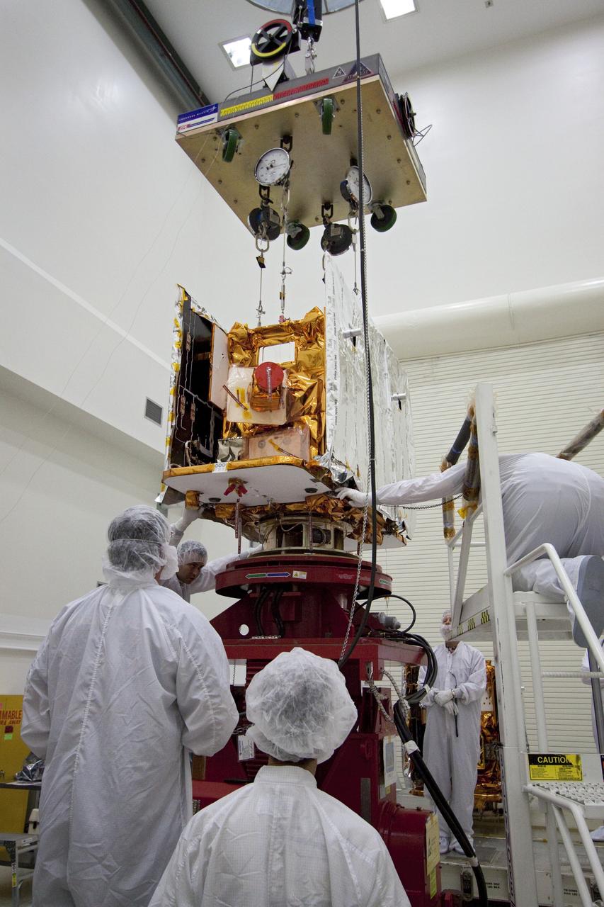 CAPE CANAVERAL, Fla. -- Technicians lower one of two spacecraft for NASA's Gravity Recovery and Interior Laboratory, or GRAIL, to a test stand in the Astrotech payload processing facility in Titusville, Fla. The twin spacecraft were built at the Lockheed Martin plant in Denver, Colo. The United Launch Alliance Delta II rocket that will carry GRAIL into lunar orbit already is fully stacked at NASA's Space Launch Complex 17B and launch is scheduled for Sept. 8. The GRAIL mission is a part of NASA's Discovery Program. GRAIL will fly twin spacecraft in tandem orbits around the moon for several months to measure its gravity field. The mission also will answer longstanding questions about Earth's moon and provide scientists a better understanding of how Earth and other rocky planets in the solar system formed. For more information, visit http://science.nasa.gov/missions/grail/. Photo credit: NASA/Jack Pfaller