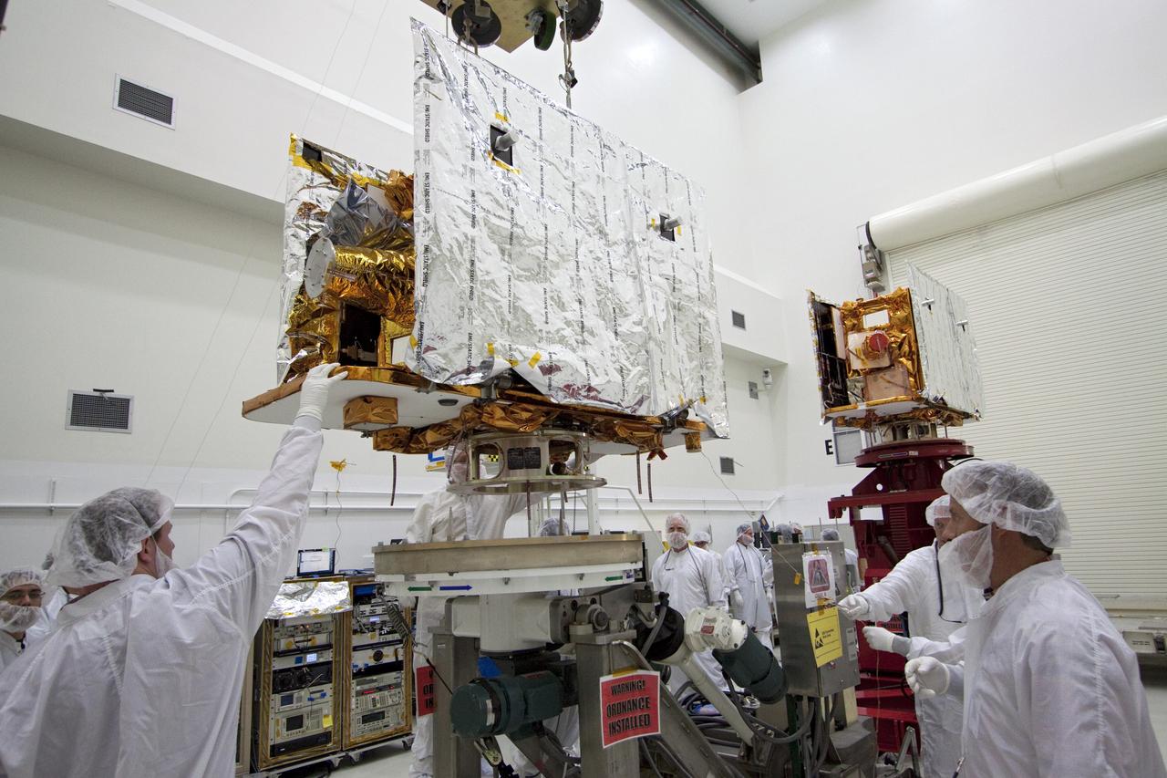 CAPE CANAVERAL, Fla. -- Technicians lower one of two spacecraft for NASA's Gravity Recovery and Interior Laboratory, or GRAIL, to a test stand in the Astrotech payload processing facility in Titusville, Fla. The twin spacecraft were built at the Lockheed Martin plant in Denver, Colo. The United Launch Alliance Delta II rocket that will carry GRAIL into lunar orbit already is fully stacked at NASA's Space Launch Complex 17B and launch is scheduled for Sept. 8. The GRAIL mission is a part of NASA's Discovery Program. GRAIL will fly twin spacecraft in tandem orbits around the moon for several months to measure its gravity field. The mission also will answer longstanding questions about Earth's moon and provide scientists a better understanding of how Earth and other rocky planets in the solar system formed. For more information, visit http://science.nasa.gov/missions/grail/. Photo credit: NASA/Jack Pfaller