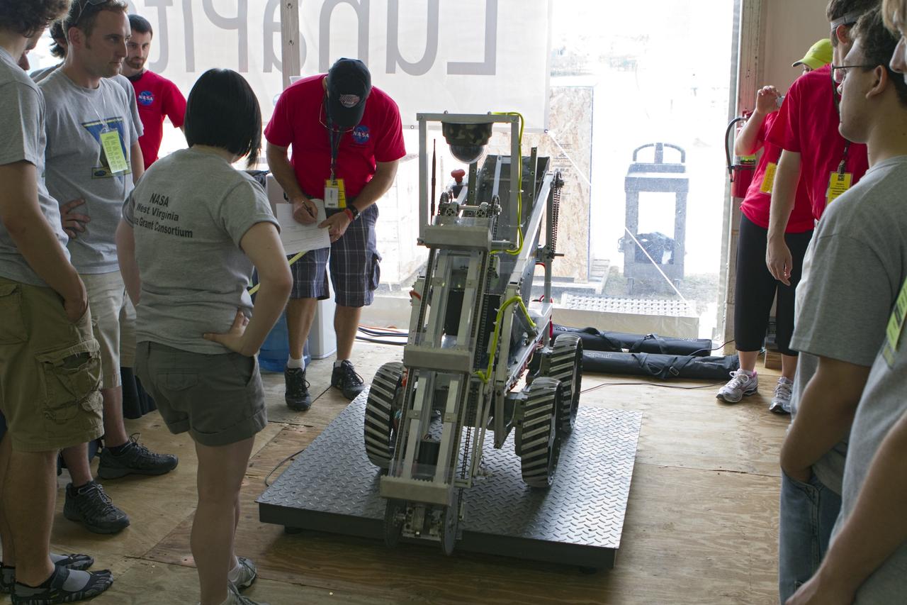 CAPE CANAVERAL, Fla. -- University students prepare for NASA's second annual Lunabotics Mining Competition at the Kennedy Space Center Visitor Complex in Florida.           Thirty-six teams of undergraduate and graduate students from the United States, Bangladesh, Canada, Colombia and India will participate in NASA's Lunabotics Mining Competition May 26 - 28. The competition is designed to engage and retain students in science, technology, engineering and mathematics (STEM). Teams will maneuver their remote controlled or autonomous excavators, called lunabots, in about 60 tons of ultra-fine simulated lunar soil, called BP-1. The competition is an Exploration Systems Mission Directorate project managed by Kennedy's Education Division. The event also provides a competitive environment that could result in innovative ideas and solutions for NASA's future excavation of the moon. Photo credit: NASA/Cory Huston
