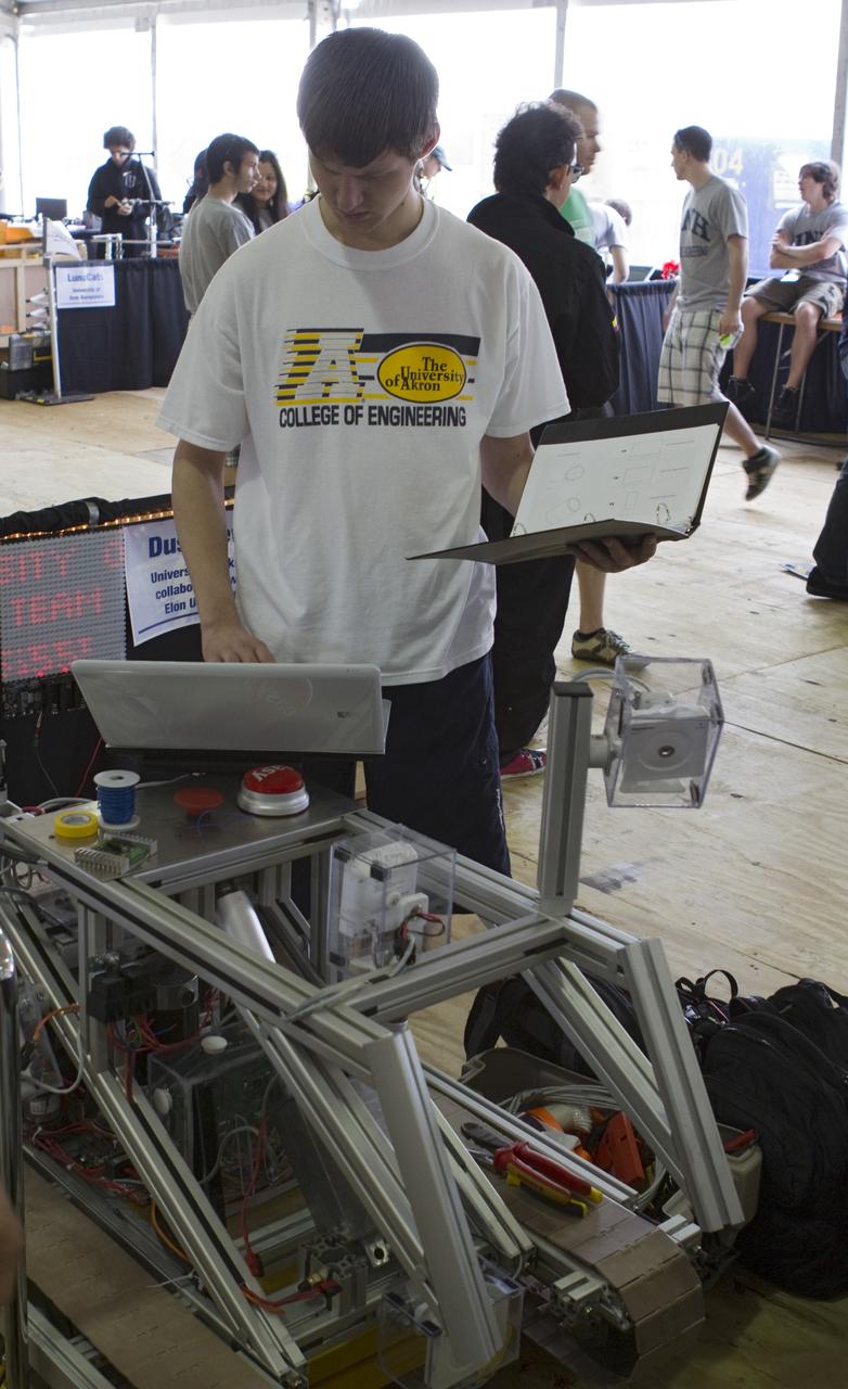 CAPE CANAVERAL, Fla. -- University students prepare for NASA's second annual Lunabotics Mining Competition at the Kennedy Space Center Visitor Complex in Florida.             Thirty-six teams of undergraduate and graduate students from the United States, Bangladesh, Canada, Colombia and India will participate in NASA's Lunabotics Mining Competition May 26 - 28. The competition is designed to engage and retain students in science, technology, engineering and mathematics (STEM). Teams will maneuver their remote controlled or autonomous excavators, called lunabots, in about 60 tons of ultra-fine simulated lunar soil, called BP-1. The competition is an Exploration Systems Mission Directorate project managed by Kennedy's Education Division. The event also provides a competitive environment that could result in innovative ideas and solutions for NASA's future excavation of the moon. Photo credit: NASA/Cory Huston