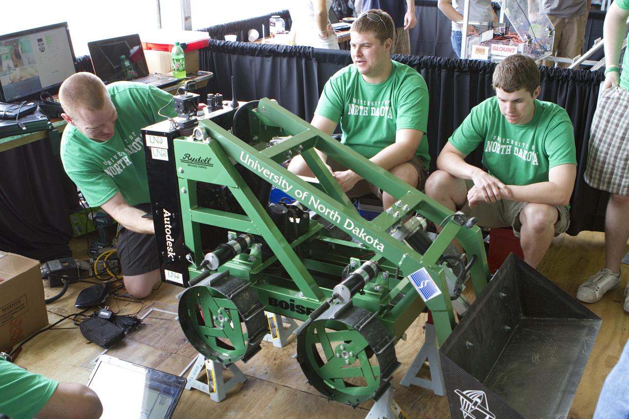 CAPE CANAVERAL, Fla. -- University students prepare for NASA's second annual Lunabotics Mining Competition at the Kennedy Space Center Visitor Complex in Florida.           Thirty-six teams of undergraduate and graduate students from the United States, Bangladesh, Canada, Colombia and India will participate in NASA's Lunabotics Mining Competition May 26 - 28. The competition is designed to engage and retain students in science, technology, engineering and mathematics (STEM). Teams will maneuver their remote controlled or autonomous excavators, called lunabots, in about 60 tons of ultra-fine simulated lunar soil, called BP-1. The competition is an Exploration Systems Mission Directorate project managed by Kennedy's Education Division. The event also provides a competitive environment that could result in innovative ideas and solutions for NASA's future excavation of the moon. Photo credit: NASA/Cory Huston