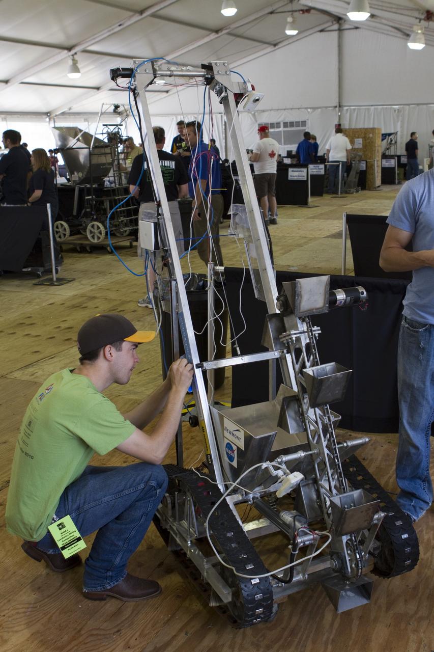 CAPE CANAVERAL, Fla. -- University students prepare for NASA's second annual Lunabotics Mining Competition at the Kennedy Space Center Visitor Complex in Florida.           Thirty-six teams of undergraduate and graduate students from the United States, Bangladesh, Canada, Colombia and India will participate in NASA's Lunabotics Mining Competition May 26 - 28. The competition is designed to engage and retain students in science, technology, engineering and mathematics (STEM). Teams will maneuver their remote controlled or autonomous excavators, called lunabots, in about 60 tons of ultra-fine simulated lunar soil, called BP-1. The competition is an Exploration Systems Mission Directorate project managed by Kennedy's Education Division. The event also provides a competitive environment that could result in innovative ideas and solutions for NASA's future excavation of the moon. Photo credit: NASA/Cory Huston