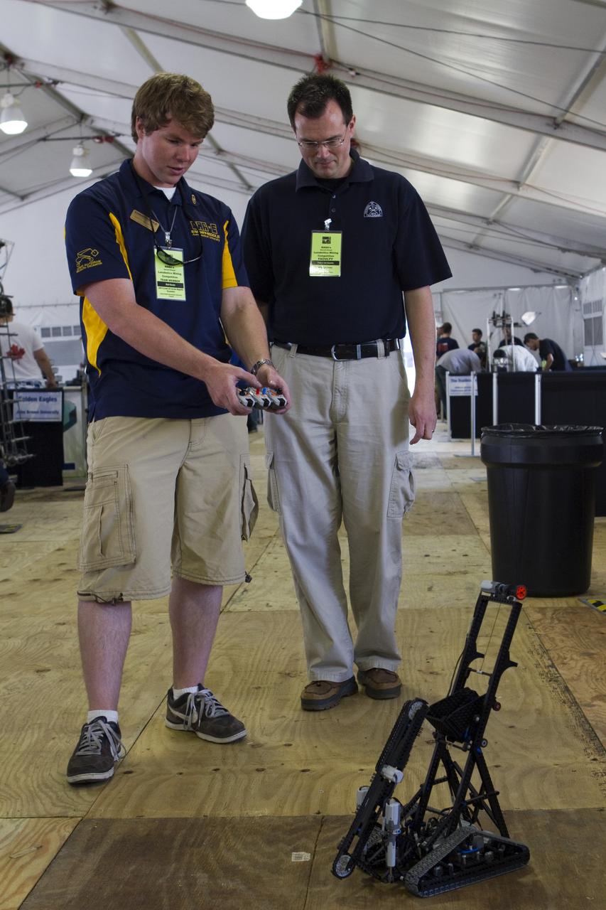 CAPE CANAVERAL, Fla. -- University students prepare for NASA's second annual Lunabotics Mining Competition at the Kennedy Space Center Visitor Complex in Florida.             Thirty-six teams of undergraduate and graduate students from the United States, Bangladesh, Canada, Colombia and India will participate in NASA's Lunabotics Mining Competition May 26 - 28. The competition is designed to engage and retain students in science, technology, engineering and mathematics (STEM). Teams will maneuver their remote controlled or autonomous excavators, called lunabots, in about 60 tons of ultra-fine simulated lunar soil, called BP-1. The competition is an Exploration Systems Mission Directorate project managed by Kennedy's Education Division. The event also provides a competitive environment that could result in innovative ideas and solutions for NASA's future excavation of the moon. Photo credit: NASA/Cory Huston