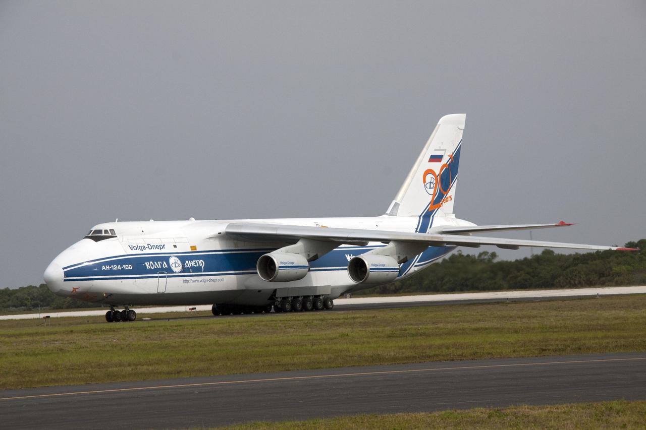 CAPE CANAVERAL, Fla. -- At Cape Canaveral Air Force Station in Florida, a Volga-Dnepr Antonov AN-124-100, a Ukranian/Russian cargo aircraft has landed on the Skid Strip. The aircraft is delivering the booster stage of a United Launch Alliance Atlas V rocket slated to launch NASA's Juno spacecraft Aug. 5.    The solar-powered spacecraft will orbit Jupiter's poles 33 times to find out more about the gas giant's origins, structure, atmosphere and magnetosphere and investigate the existence of a solid planetary core. For more information visit: www.nasa.gov/juno. Photo credit: NASA/Jack Pfaller
