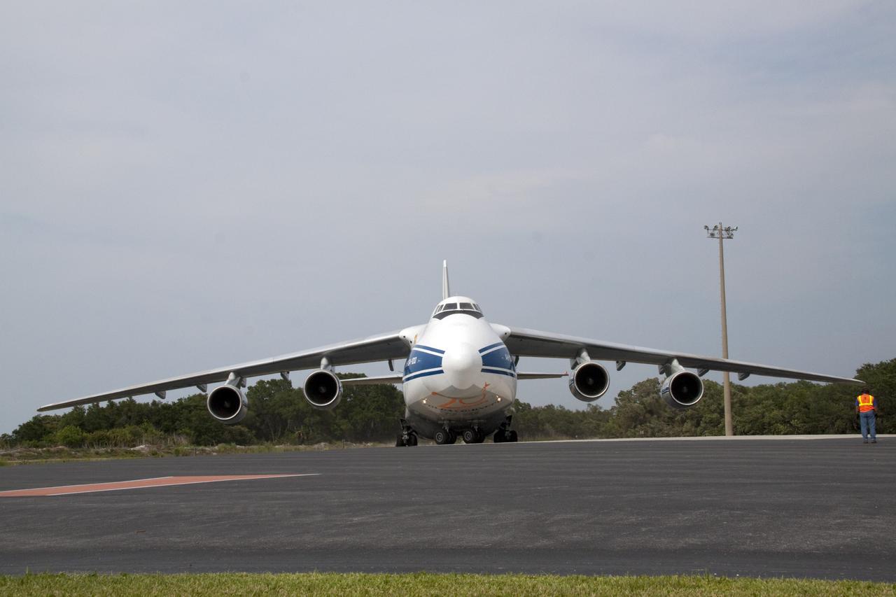 CAPE CANAVERAL, Fla. -- At Cape Canaveral Air Force Station in Florida, a Volga-Dnepr Antonov AN-124-100, a Ukranian/Russian cargo aircraft has landed on the Skid Strip. The aircraft is delivering the booster stage of a United Launch Alliance Atlas V rocket slated to launch NASA's Juno spacecraft Aug. 5.    The solar-powered spacecraft will orbit Jupiter's poles 33 times to find out more about the gas giant's origins, structure, atmosphere and magnetosphere and investigate the existence of a solid planetary core. For more information visit: www.nasa.gov/juno. Photo credit: NASA/Jack Pfaller
