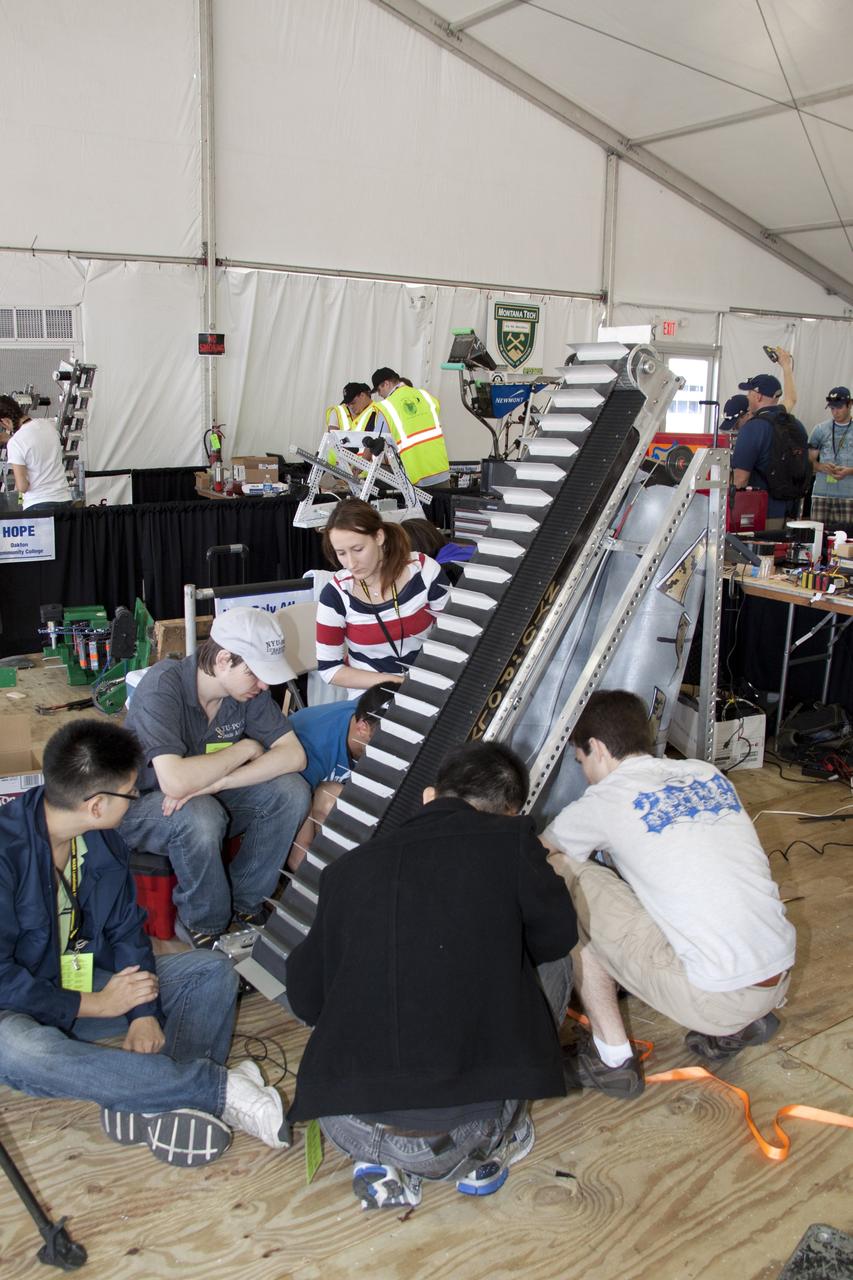 CAPE CANAVERAL, Fla. -- University students prepare for NASA's second annual Lunabotics Mining Competition at the Kennedy Space Center Visitor Complex in Florida.             Thirty-six teams of undergraduate and graduate students from the United States, Bangladesh, Canada, Colombia and India will participate in NASA's Lunabotics Mining Competition May 26 - 28 at the agency's Kennedy Space Center in Florida. The competition is designed to engage and retain students in science, technology, engineering and mathematics (STEM). Teams will maneuver their remote controlled or autonomous excavators, called lunabots, in about 60 tons of ultra-fine simulated lunar soil, called BP-1. The competition is an Exploration Systems Mission Directorate project managed by Kennedy's Education Division. The event also provides a competitive environment that could result in innovative ideas and solutions for NASA's future excavation of the moon. Photo credit: NASA/Jack Pfaller