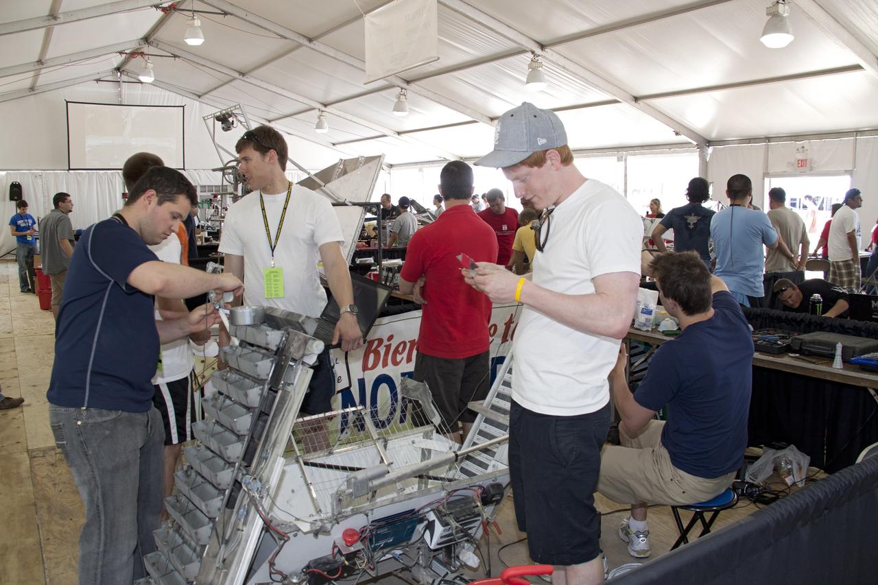CAPE CANAVERAL, Fla. -- University students prepare for NASA's second annual Lunabotics Mining Competition at the Kennedy Space Center Visitor Complex in Florida.               Thirty-six teams of undergraduate and graduate students from the United States, Bangladesh, Canada, Colombia and India will participate in NASA's Lunabotics Mining Competition May 26 - 28 at the agency's Kennedy Space Center in Florida. The competition is designed to engage and retain students in science, technology, engineering and mathematics (STEM). Teams will maneuver their remote controlled or autonomous excavators, called lunabots, in about 60 tons of ultra-fine simulated lunar soil, called BP-1. The competition is an Exploration Systems Mission Directorate project managed by Kennedy's Education Division. The event also provides a competitive environment that could result in innovative ideas and solutions for NASA's future excavation of the moon. Photo credit: NASA/Jack Pfaller
