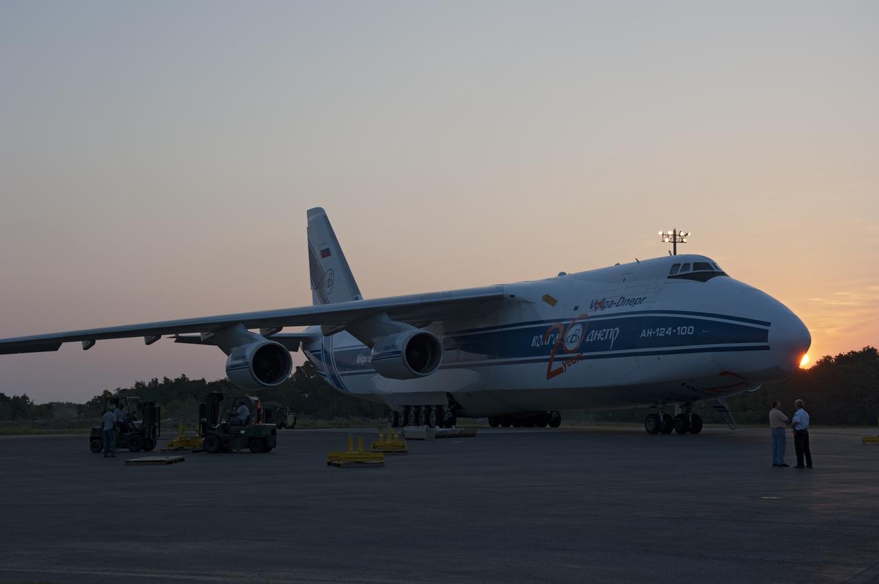 CAPE CANAVERAL, Fla. -- On the Skid Strip at Cape Canaveral Air Force Station in Florida, workers prepare to unload a Volga-Dnepr Antonov AN-124-100, a Ukranian/Russian cargo aircraft that has delivered the first stage of the United Launch Alliance Atlas V rocket slated to launch NASA's Juno spacecraft.    Juno is scheduled to launch aboard an Atlas V rocket from Cape Canaveral, Fla., Aug. 5.The solar-powered spacecraft will orbit Jupiter's poles 33 times to find out more about the gas giant's origins, structure, atmosphere and magnetosphere and investigate the existence of a solid planetary core.  For more information, visit www.nasa.gov/juno.  Photo credit: NASA/Kim Shiflett