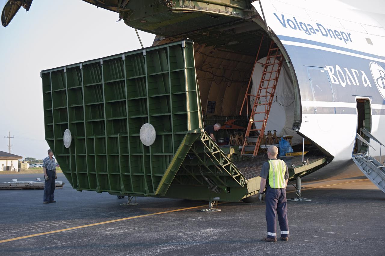 CAPE CANAVERAL, Fla. -- On the Skid Strip at Cape Canaveral Air Force Station in Florida, workers prepare to unload a Volga-Dnepr Antonov AN-124-100, a Ukranian/Russian cargo aircraft that has delivered the first stage of the United Launch Alliance Atlas V rocket slated to launch NASA's Juno spacecraft. Juno is scheduled to launch aboard an Atlas V rocket from Cape Canaveral, Fla., Aug. 5.The solar-powered spacecraft will orbit Jupiter's poles 33 times to find out more about the gas giant's origins, structure, atmosphere and magnetosphere and investigate the existence of a solid planetary core. For more information, visit www.nasa.gov/juno. Photo credit: NASA/Kim Shiflett