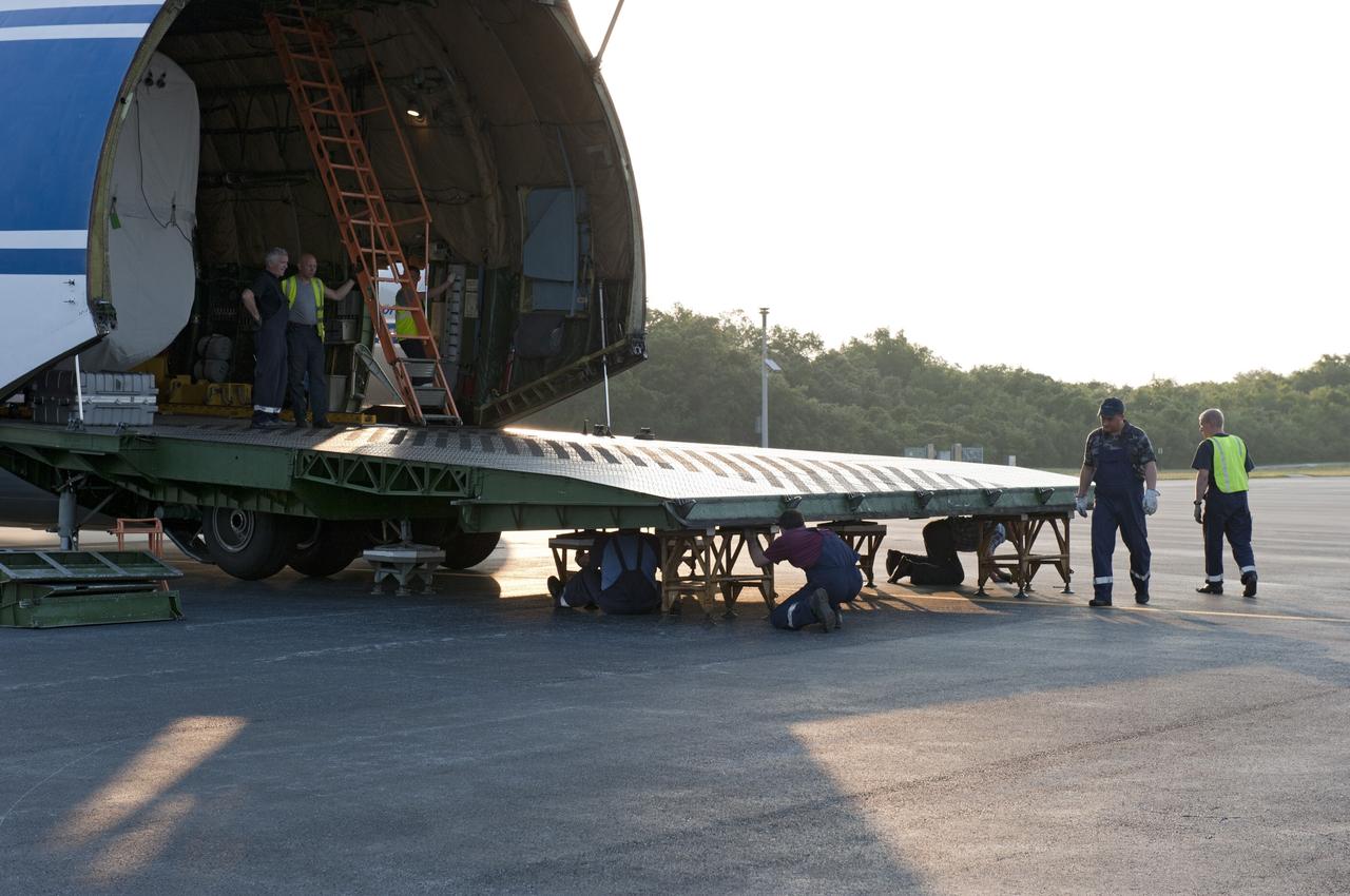 CAPE CANAVERAL, Fla. -- On the Skid Strip at Cape Canaveral Air Force Station in Florida, workers prepare to unload a Volga-Dnepr Antonov AN-124-100, a Ukranian/Russian cargo aircraft that has delivered the first stage of the United Launch Alliance Atlas V rocket slated to launch NASA's Juno spacecraft.    Juno is scheduled to launch aboard an Atlas V rocket from Cape Canaveral, Fla., Aug. 5.The solar-powered spacecraft will orbit Jupiter's poles 33 times to find out more about the gas giant's origins, structure, atmosphere and magnetosphere and investigate the existence of a solid planetary core.  For more information, visit www.nasa.gov/juno.  Photo credit: NASA/Kim Shiflett