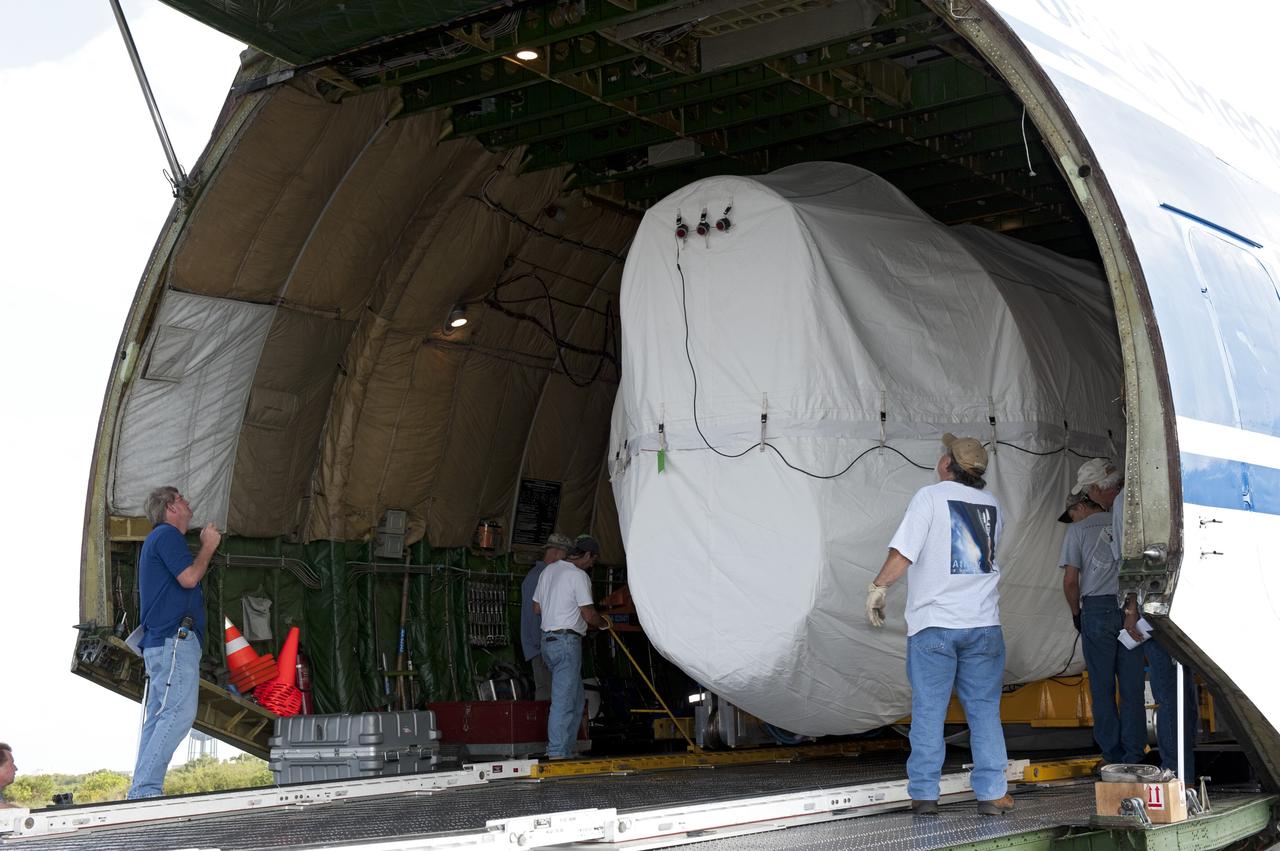 CAPE CANAVERAL, Fla. -- On the Skid Strip at Cape Canaveral Air Force Station in Florida, workers begin to unload the first stage of the United Launch Alliance Atlas V rocket slated to launch NASA's Juno spacecraft from a Volga-Dnepr Antonov AN-124-100, a Ukranian/Russian cargo aircraft.    Juno is scheduled to launch aboard an Atlas V rocket from Cape Canaveral, Fla., Aug. 5.The solar-powered spacecraft will orbit Jupiter's poles 33 times to find out more about the gas giant's origins, structure, atmosphere and magnetosphere and investigate the existence of a solid planetary core.  For more information, visit www.nasa.gov/juno.  Photo credit: NASA/Kim Shiflett