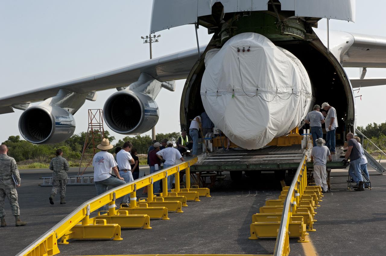 CAPE CANAVERAL, Fla. -- On the Skid Strip at Cape Canaveral Air Force Station in Florida, workers unload the first stage of the United Launch Alliance Atlas V rocket slated to launch NASA's Juno spacecraft from a Volga-Dnepr Antonov AN-124-100, a Ukranian/Russian cargo aircraft.    Juno is scheduled to launch aboard an Atlas V rocket from Cape Canaveral, Fla., Aug. 5.The solar-powered spacecraft will orbit Jupiter's poles 33 times to find out more about the gas giant's origins, structure, atmosphere and magnetosphere and investigate the existence of a solid planetary core.  For more information, visit www.nasa.gov/juno.  Photo credit: NASA/Kim Shiflett