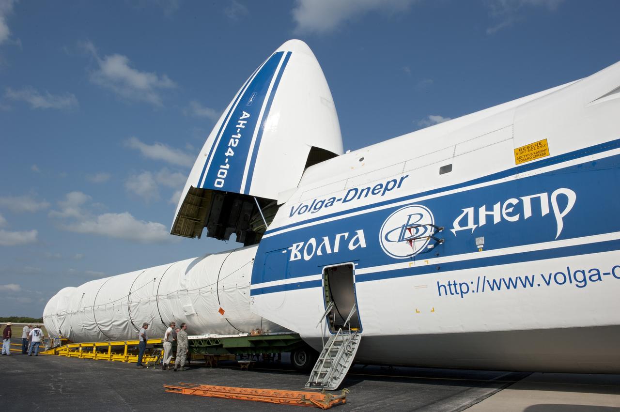 CAPE CANAVERAL, Fla. -- On the Skid Strip at Cape Canaveral Air Force Station in Florida, workers unload the first stage of the United Launch Alliance Atlas V rocket slated to launch NASA's Juno spacecraft from a Volga-Dnepr Antonov AN-124-100, a Ukranian/Russian cargo aircraft.    Juno is scheduled to launch aboard an Atlas V rocket from Cape Canaveral, Fla., Aug. 5.The solar-powered spacecraft will orbit Jupiter's poles 33 times to find out more about the gas giant's origins, structure, atmosphere and magnetosphere and investigate the existence of a solid planetary core.  For more information, visit www.nasa.gov/juno.  Photo credit: NASA/Kim Shiflett