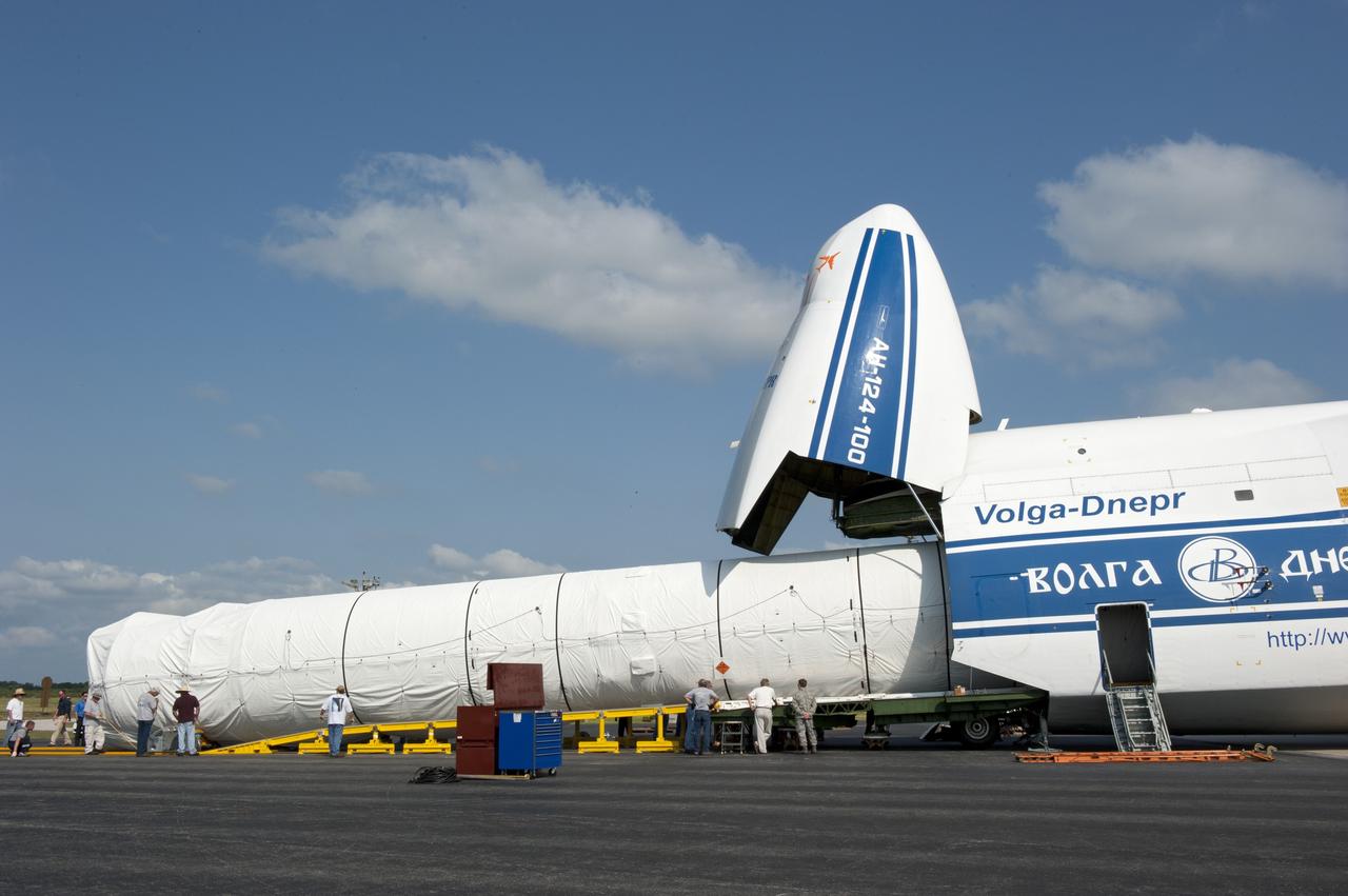 CAPE CANAVERAL, Fla. -- On the Skid Strip at Cape Canaveral Air Force Station in Florida, workers unload the first stage of the United Launch Alliance Atlas V rocket slated to launch NASA's Juno spacecraft from a Volga-Dnepr Antonov AN-124-100, a Ukranian/Russian cargo aircraft.    Juno is scheduled to launch aboard an Atlas V rocket from Cape Canaveral, Fla., Aug. 5.The solar-powered spacecraft will orbit Jupiter's poles 33 times to find out more about the gas giant's origins, structure, atmosphere and magnetosphere and investigate the existence of a solid planetary core.  For more information, visit www.nasa.gov/juno.  Photo credit: NASA/Kim Shiflett