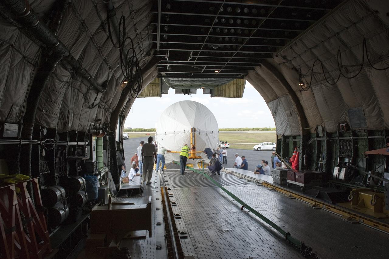 CAPE CANAVERAL, Fla. -- On the Skid Strip at Cape Canaveral Air Force Station in Florida, workers unload the first stage of the United Launch Alliance Atlas V rocket slated to launch NASA's Juno spacecraft from a Volga-Dnepr Antonov AN-124-100, a Ukranian/Russian cargo aircraft.    Juno is scheduled to launch aboard an Atlas V rocket from Cape Canaveral, Fla., Aug. 5.The solar-powered spacecraft will orbit Jupiter's poles 33 times to find out more about the gas giant's origins, structure, atmosphere and magnetosphere and investigate the existence of a solid planetary core.  For more information, visit www.nasa.gov/juno.  Photo credit: NASA/Kim Shiflett