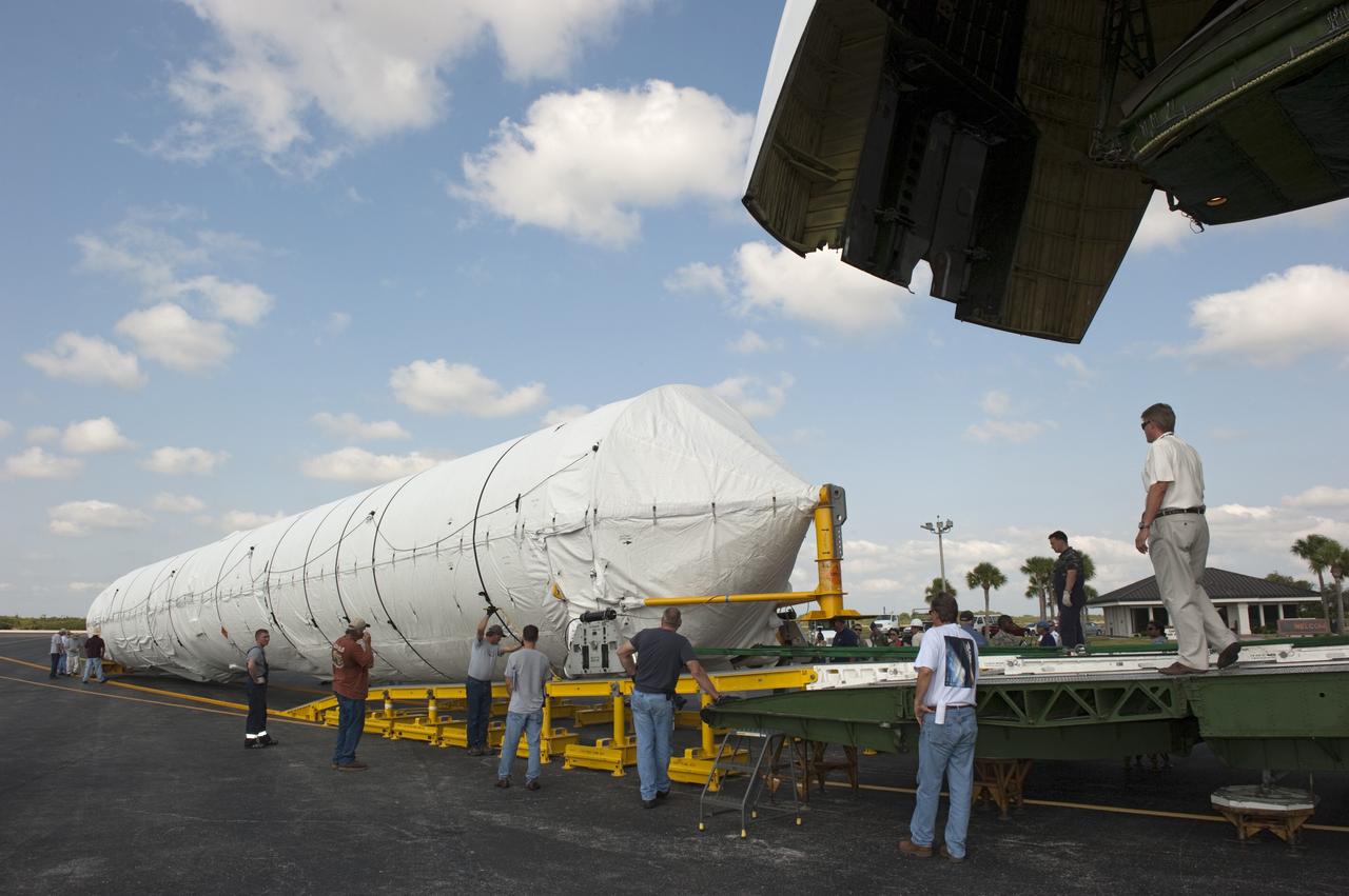 CAPE CANAVERAL, Fla. -- On the Skid Strip at Cape Canaveral Air Force Station in Florida, workers unload the first stage of the United Launch Alliance Atlas V rocket slated to launch NASA's Juno spacecraft from a Volga-Dnepr Antonov AN-124-100, a Ukranian/Russian cargo aircraft.    Juno is scheduled to launch aboard an Atlas V rocket from Cape Canaveral, Fla., Aug. 5.The solar-powered spacecraft will orbit Jupiter's poles 33 times to find out more about the gas giant's origins, structure, atmosphere and magnetosphere and investigate the existence of a solid planetary core.  For more information, visit www.nasa.gov/juno.  Photo credit: NASA/Kim Shiflett