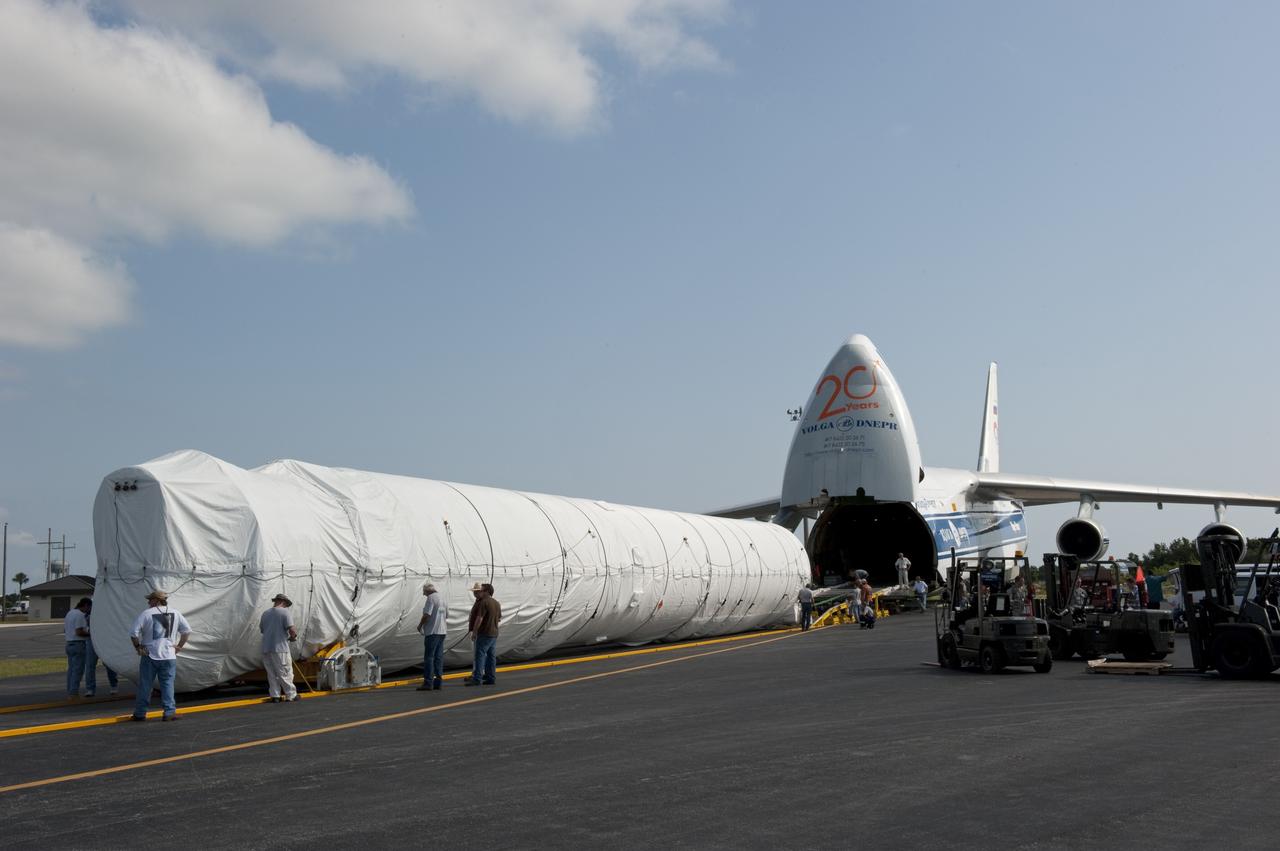 CAPE CANAVERAL, Fla. -- On the Skid Strip at Cape Canaveral Air Force Station in Florida, workers have unloaded the first stage of the United Launch Alliance Atlas V rocket slated to launch NASA's Juno spacecraft from a Volga-Dnepr Antonov AN-124-100, a Ukranian/Russian cargo aircraft.    Juno is scheduled to launch aboard an Atlas V rocket from Cape Canaveral, Fla., Aug. 5.The solar-powered spacecraft will orbit Jupiter's poles 33 times to find out more about the gas giant's origins, structure, atmosphere and magnetosphere and investigate the existence of a solid planetary core.  For more information, visit www.nasa.gov/juno.  Photo credit: NASA/Kim Shiflett
