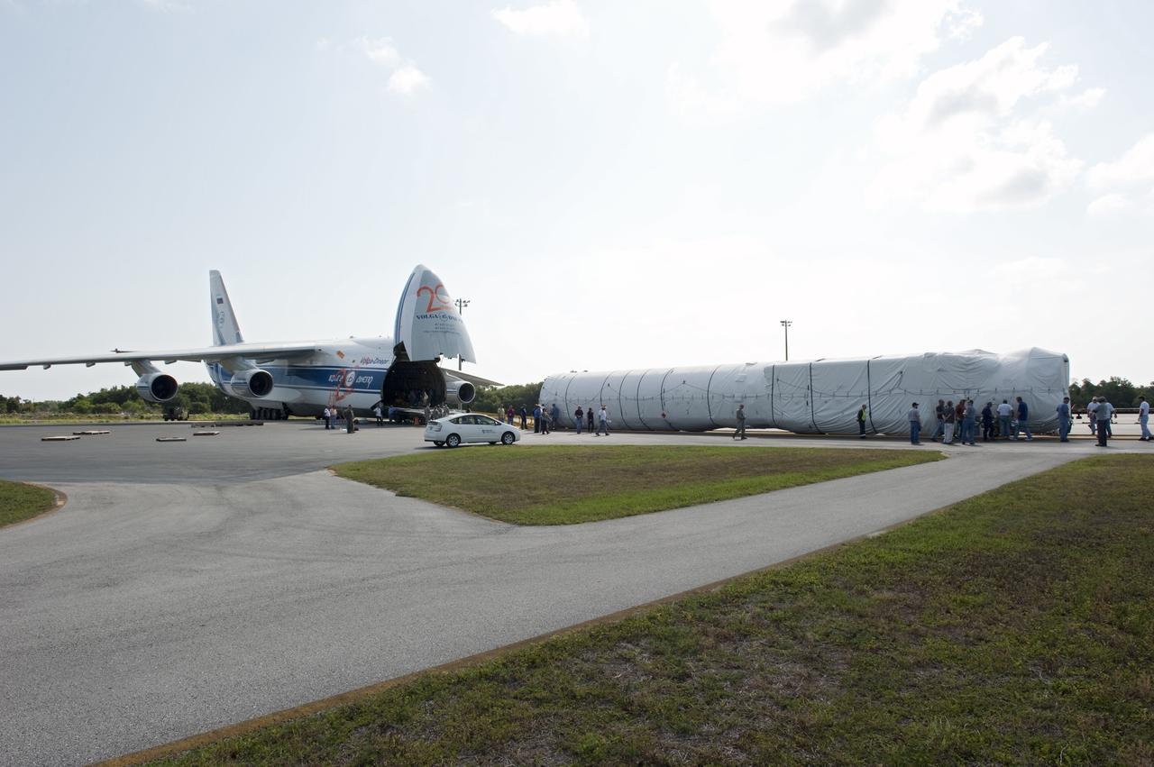 CAPE CANAVERAL, Fla. -- On the Skid Strip at Cape Canaveral Air Force Station in Florida, workers have unloaded the first stage of the United Launch Alliance Atlas V rocket slated to launch NASA's Juno spacecraft from a Volga-Dnepr Antonov AN-124-100, a Ukranian/Russian cargo aircraft.    Juno is scheduled to launch aboard an Atlas V rocket from Cape Canaveral, Fla., Aug. 5.The solar-powered spacecraft will orbit Jupiter's poles 33 times to find out more about the gas giant's origins, structure, atmosphere and magnetosphere and investigate the existence of a solid planetary core.  For more information, visit www.nasa.gov/juno.  Photo credit: NASA/Kim Shiflett