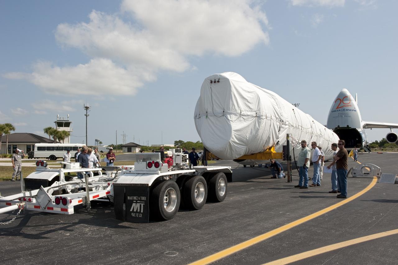 CAPE CANAVERAL, Fla. -- On the Skid Strip at Cape Canaveral Air Force Station in Florida, workers begin to load the first stage of the United Launch Alliance Atlas V rocket slated to launch NASA's Juno spacecraft onto a transporter.    Juno is scheduled to launch aboard an Atlas V rocket from Cape Canaveral, Fla., Aug. 5.The solar-powered spacecraft will orbit Jupiter's poles 33 times to find out more about the gas giant's origins, structure, atmosphere and magnetosphere and investigate the existence of a solid planetary core.  For more information, visit www.nasa.gov/juno.  Photo credit: NASA/Kim Shiflett