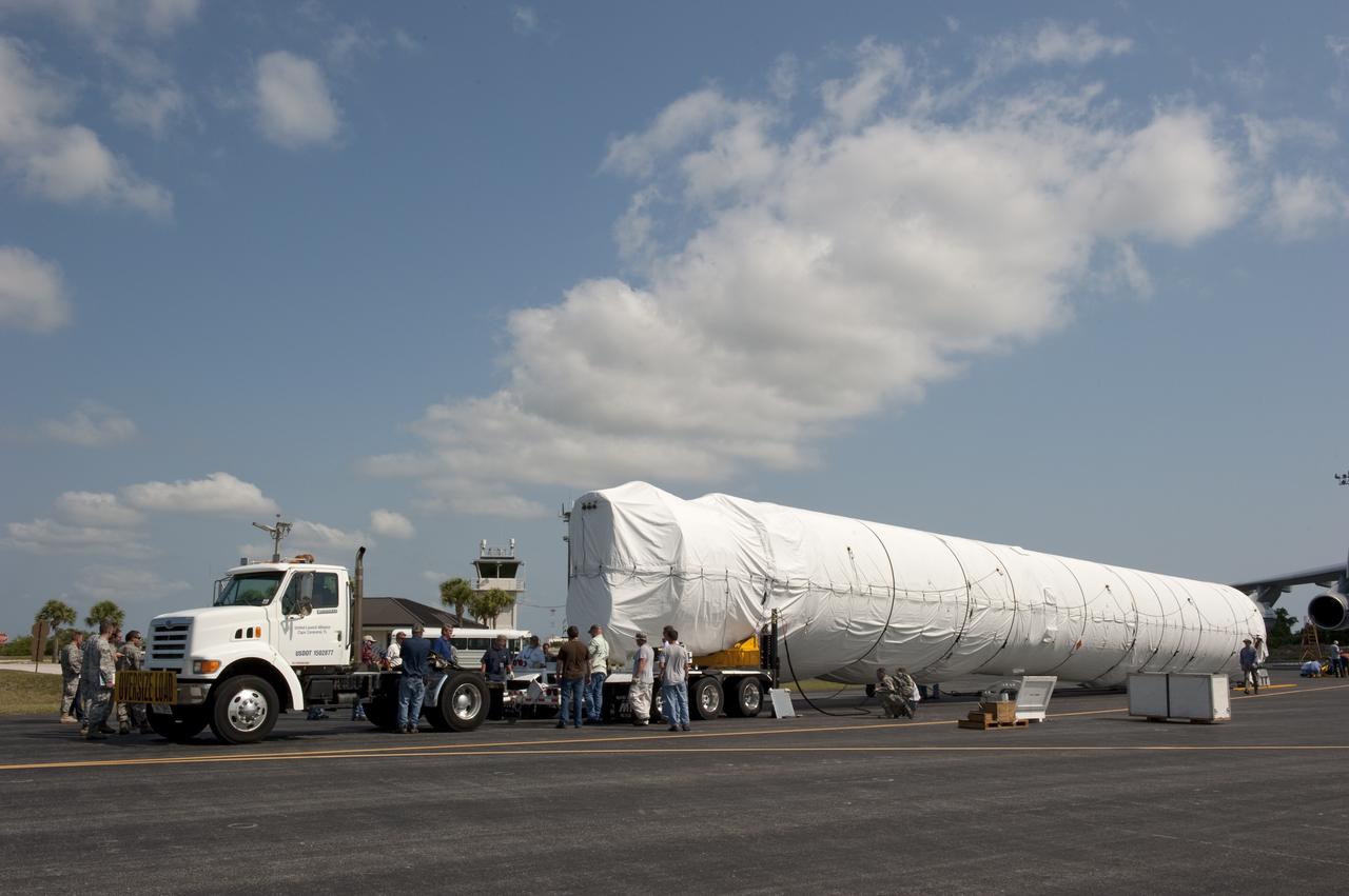 CAPE CANAVERAL, Fla. -- On the Skid Strip at Cape Canaveral Air Force Station in Florida, workers are loading the first stage of the United Launch Alliance Atlas V rocket slated to launch NASA's Juno spacecraft onto a transporter.    Juno is scheduled to launch aboard an Atlas V rocket from Cape Canaveral, Fla., Aug. 5.The solar-powered spacecraft will orbit Jupiter's poles 33 times to find out more about the gas giant's origins, structure, atmosphere and magnetosphere and investigate the existence of a solid planetary core.  For more information, visit www.nasa.gov/juno.  Photo credit: NASA/Kim Shiflett