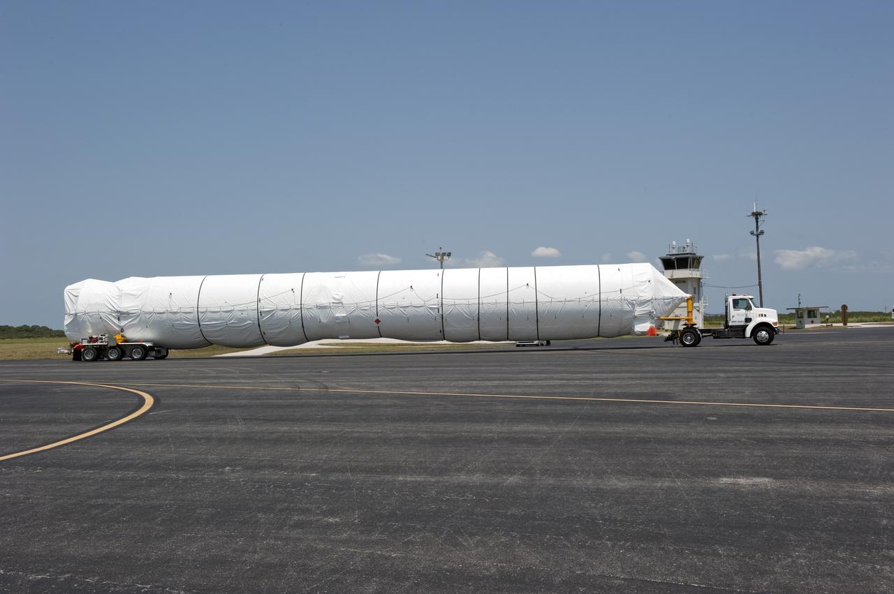 CAPE CANAVERAL, Fla. -- On the Skid Strip at Cape Canaveral Air Force Station in Florida, workers have loaded the first stage of the United Launch Alliance Atlas V rocket slated to launch NASA's Juno spacecraft onto a transporter for its transfer to the Atlas Spaceflight Operations Center.    Juno is scheduled to launch aboard an Atlas V rocket from Cape Canaveral, Fla., Aug. 5.The solar-powered spacecraft will orbit Jupiter's poles 33 times to find out more about the gas giant's origins, structure, atmosphere and magnetosphere and investigate the existence of a solid planetary core.  For more information, visit www.nasa.gov/juno.  Photo credit: NASA/Kim Shiflett