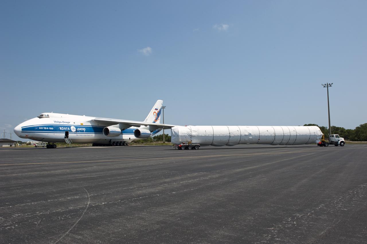 CAPE CANAVERAL, Fla. -- The first stage for the United Launch Alliance Atlas V rocket slated to launch NASA's Juno spacecraft is being transported from the Skid Strip on Cape Canaveral Air Force Station in Florida to the Atlas Spaceflight Operations Center.    Juno is scheduled to launch aboard an Atlas V rocket from Cape Canaveral, Fla., Aug. 5.The solar-powered spacecraft will orbit Jupiter's poles 33 times to find out more about the gas giant's origins, structure, atmosphere and magnetosphere and investigate the existence of a solid planetary core.  For more information, visit www.nasa.gov/juno.  Photo credit: NASA/Kim Shiflett