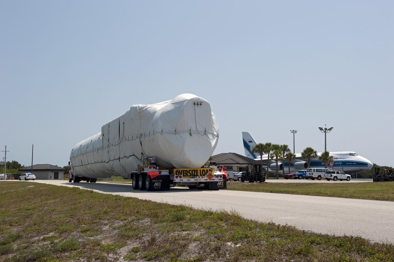 CAPE CANAVERAL, Fla. -- The first stage for the United Launch Alliance Atlas V rocket slated to launch NASA's Juno spacecraft is being transported from the Skid Strip on Cape Canaveral Air Force Station in Florida to the Atlas Spaceflight Operations Center.    Juno is scheduled to launch aboard an Atlas V rocket from Cape Canaveral, Fla., Aug. 5.The solar-powered spacecraft will orbit Jupiter's poles 33 times to find out more about the gas giant's origins, structure, atmosphere and magnetosphere and investigate the existence of a solid planetary core.  For more information, visit www.nasa.gov/juno.  Photo credit: NASA/Kim Shiflett