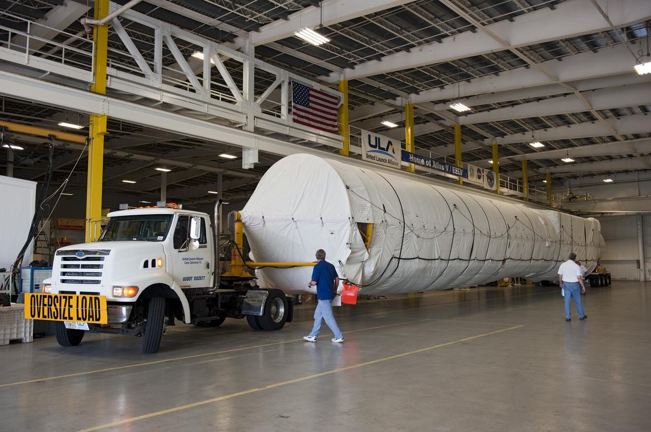 CAPE CANAVERAL, Fla. -- The first stage for the United Launch Alliance Atlas V rocket slated to launch NASA's Juno spacecraft has arrived at the Atlas Spaceflight Operations Center at Cape Canaveral Air Force Station in Florida.     Juno is scheduled to launch aboard an Atlas V rocket from Cape Canaveral, Fla., Aug. 5.The solar-powered spacecraft will orbit Jupiter's poles 33 times to find out more about the gas giant's origins, structure, atmosphere and magnetosphere and investigate the existence of a solid planetary core.  For more information, visit www.nasa.gov/juno.  Photo credit: NASA/Kim Shiflett