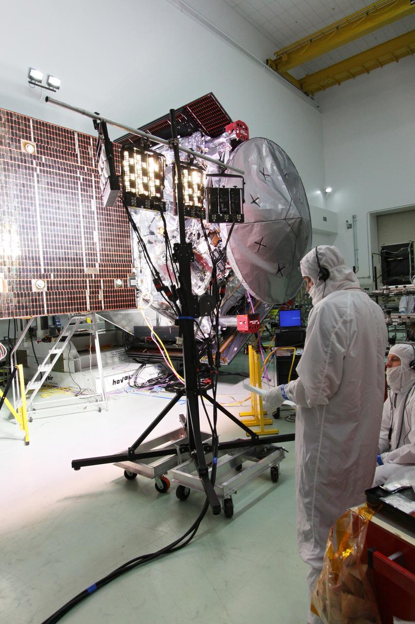 CAPE CANAVERAL, Fla. -- At Astrotech Space Operations in Titusville, Fla., technicians conduct illumination tests on solar array panel #1 with its magnetometer boom for NASA's Juno spacecraft.        Juno is scheduled to launch aboard a United Launch Alliance Atlas V from Cape Canaveral, Fla. Aug. 5.The solar-powered spacecraft will orbit Jupiter's poles 33 times to find out more about the gas giant's origins, structure, atmosphere and magnetosphere and investigate the existence of a solid planetary core. For more information visit: www.nasa.gov/juno. Photo credit: NASA/Jack Pfaller