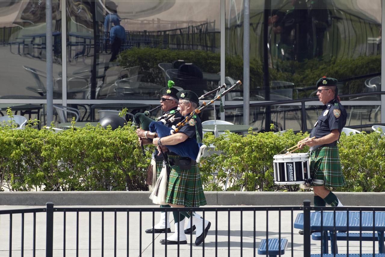 CAPE CANAVERAL, Fla. -- The Miami Beach Police Department Celtic Pride Bagpipe and Drum Corps play the bagpipes as they make their way to the Astronaut Memorial Mirror at NASA's Kennedy Space Center Visitor Complex for the U.S. Honor Flag presentation ceremony.               The flag will be presented to NASA to be prepared to fly aboard space shuttle Atlantis on the Space Shuttle Program's final mission, STS-135. The U.S. Honor Flag has been flown nationwide, at Ground Zero and throughout the world to honor heroes who have lost their lives while serving their community and country, including police officers, firefighters, members of the Armed Forces and astronauts. More than 100 honor guard members traveled to the Space Coast to take part in the ceremony. After the flag returns to Earth, it will continue as a traveling memorial. Photo credit: NASA/Kim Shiflett