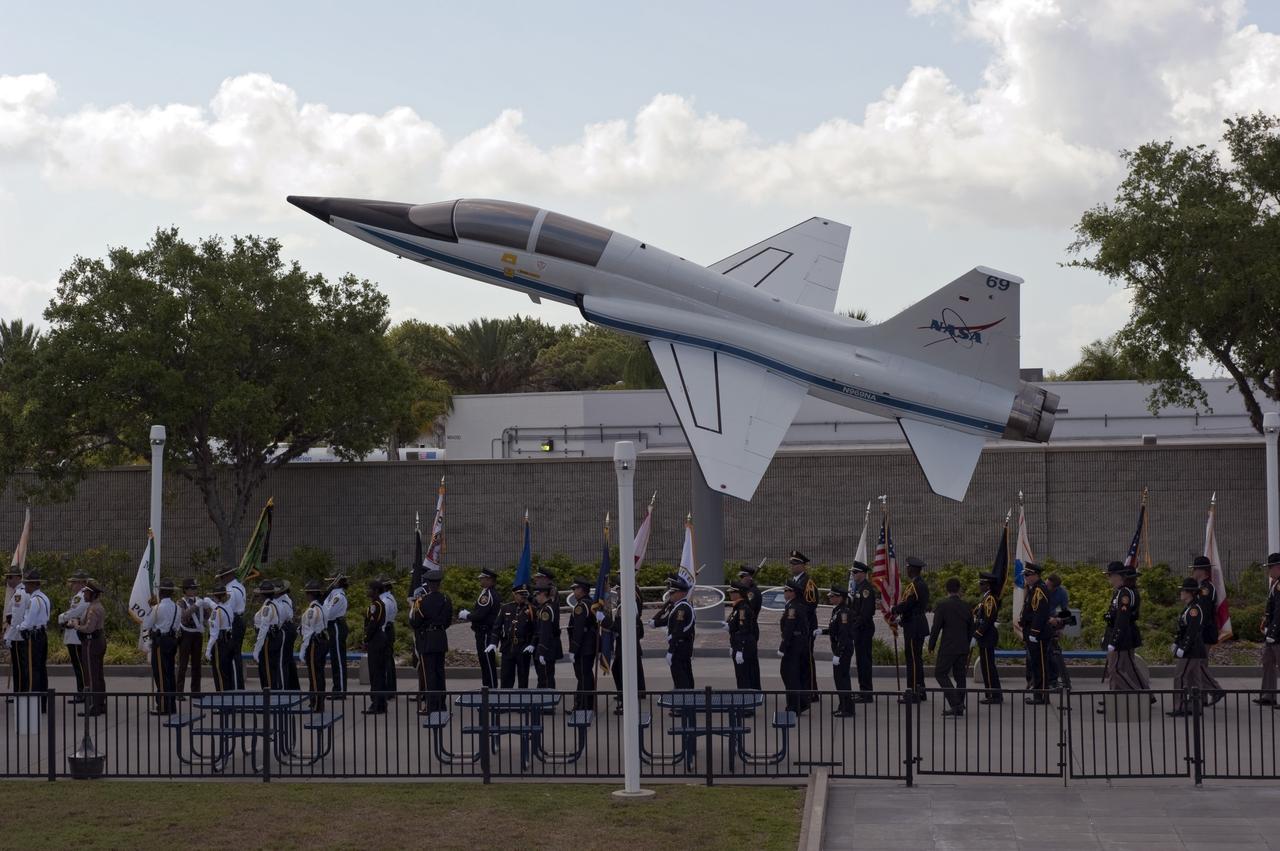 CAPE CANAVERAL, Fla. -- Honor guards march to the Astronaut Memorial Mirror at NASA's Kennedy Space Center Visitor Complex to participate in a U.S. Honor Flag presentation ceremony.             The flag is presented to NASA to be prepared to fly aboard space shuttle Atlantis on the Space Shuttle Program's final mission, STS-135. The U.S. Honor Flag has been flown nationwide, at Ground Zero and throughout the world to honor heroes who have lost their lives while serving their community and country, including police officers, firefighters, members of the Armed Forces and astronauts. More than 100 honor guard members traveled to the Space Coast to take part in the ceremony. After the flag returns to Earth, it will continue as a traveling memorial. Photo credit: NASA/Kim Shiflett