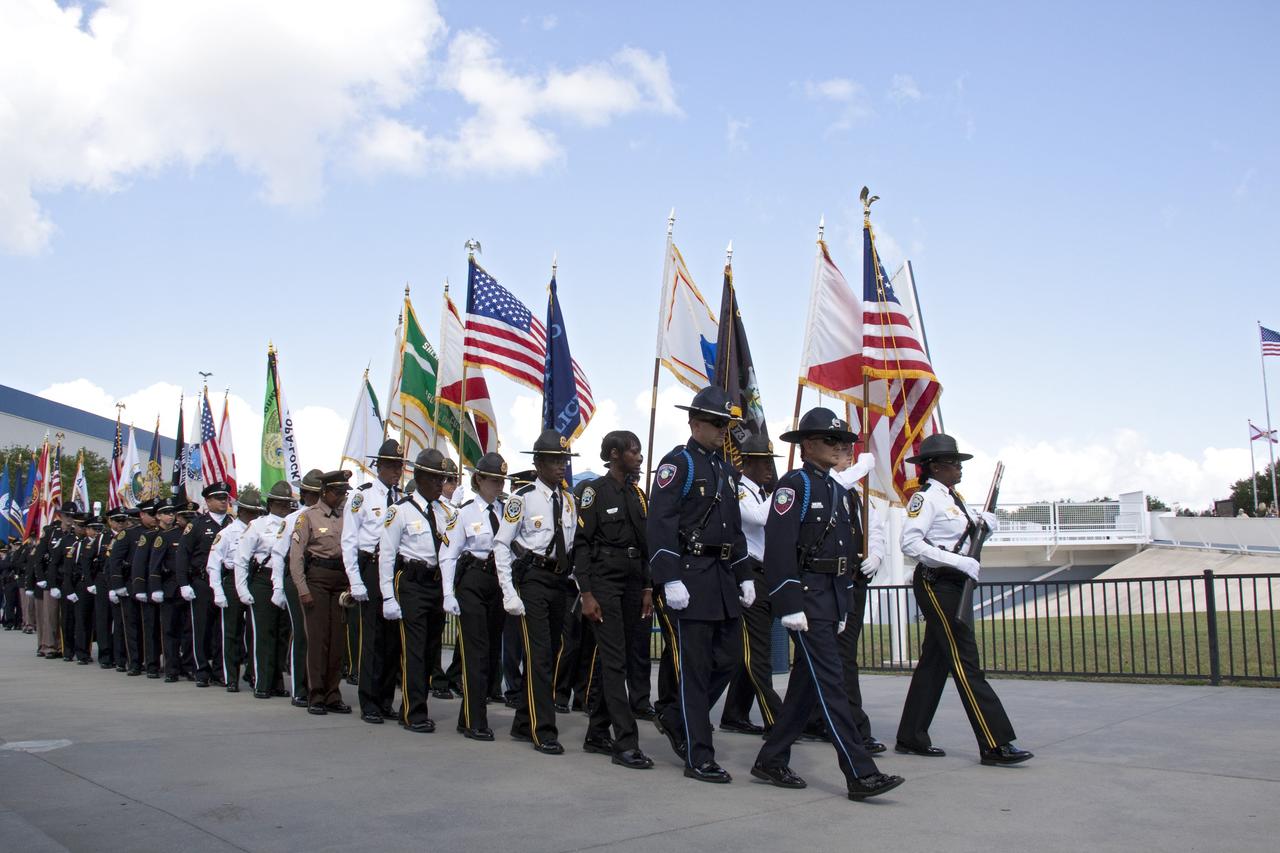 CAPE CANAVERAL, Fla. -- Honor guards march to the Astronaut Memorial Mirror at NASA's Kennedy Space Center Visitor Complex to participate in a U.S. Honor Flag presentation ceremony.           The flag is presented to NASA to be prepared to fly aboard space shuttle Atlantis on the Space Shuttle Program's final mission, STS-135. The U.S. Honor Flag has been flown nationwide, at Ground Zero and throughout the world to honor heroes who have lost their lives while serving their community and country, including police officers, firefighters, members of the Armed Forces and astronauts. More than 100 honor guard members traveled to the Space Coast to take part in the ceremony. After the flag returns to Earth, it will continue as a traveling memorial. Photo credit: NASA/Troy Cryder