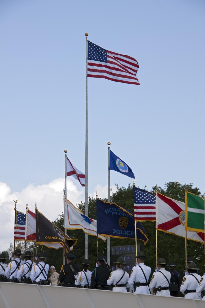 CAPE CANAVERAL, Fla. -- Honor guards march to the Astronaut Memorial Mirror at NASA's Kennedy Space Center Visitor Complex to participate in a U.S. Honor Flag presentation ceremony.           The flag is presented to NASA to be prepared to fly aboard space shuttle Atlantis on the Space Shuttle Program's final mission, STS-135. The U.S. Honor Flag has been flown nationwide, at Ground Zero and throughout the world to honor heroes who have lost their lives while serving their community and country, including police officers, firefighters, members of the Armed Forces and astronauts. More than 100 honor guard members traveled to the Space Coast to take part in the ceremony. After the flag returns to Earth, it will continue as a traveling memorial. Photo credit: NASA/Troy Cryder
