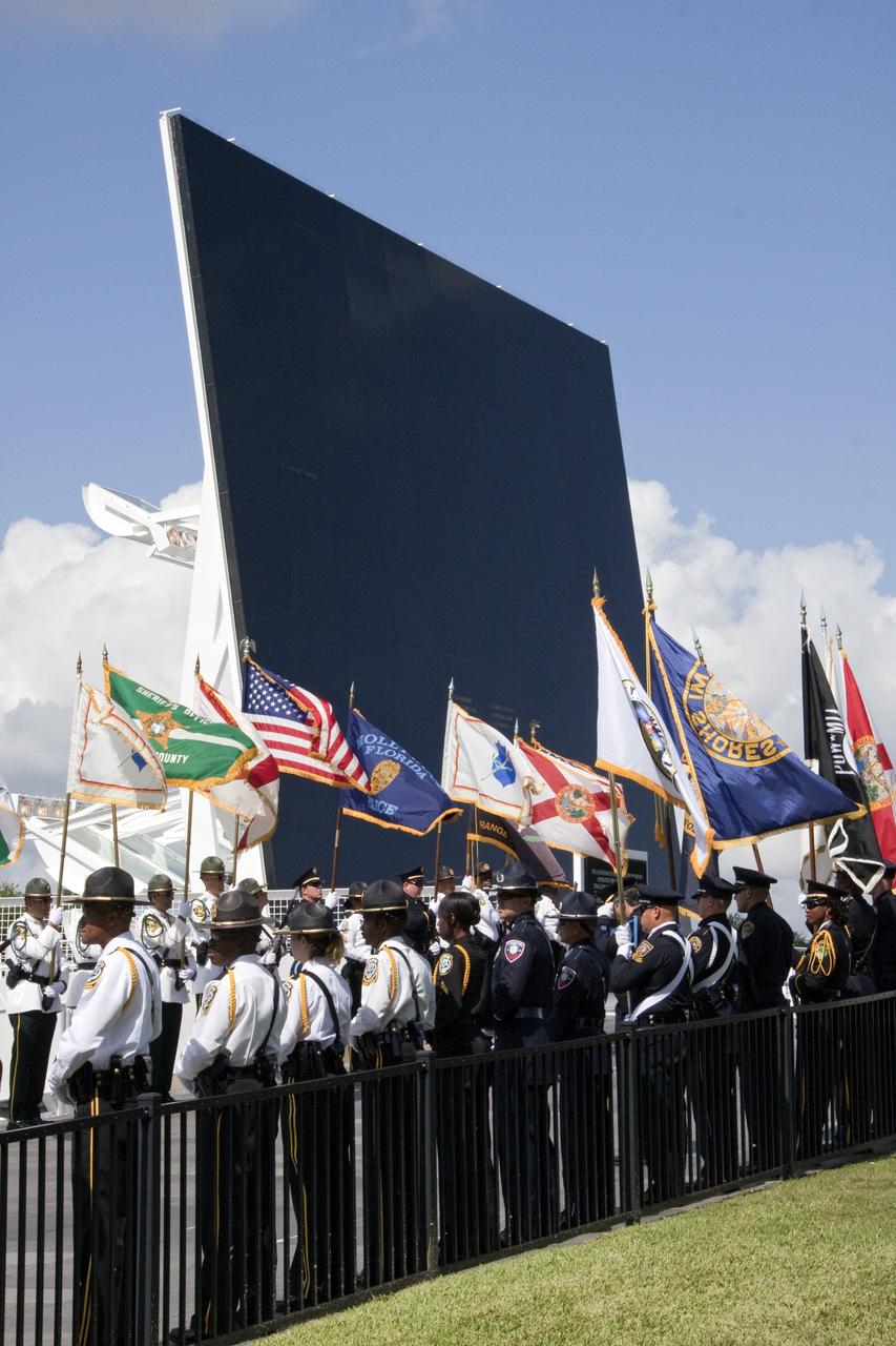 CAPE CANAVERAL, Fla. -- Honor guards march to the Astronaut Memorial Mirror at NASA's Kennedy Space Center Visitor Complex to participate in a U.S. Honor Flag presentation ceremony.           The flag is presented to NASA to be prepared to fly aboard space shuttle Atlantis on the Space Shuttle Program's final mission, STS-135. The U.S. Honor Flag has been flown nationwide, at Ground Zero and throughout the world to honor heroes who have lost their lives while serving their community and country, including police officers, firefighters, members of the Armed Forces and astronauts. More than 100 honor guard members traveled to the Space Coast to take part in the ceremony. After the flag returns to Earth, it will continue as a traveling memorial. Photo credit: NASA/Troy Cryder