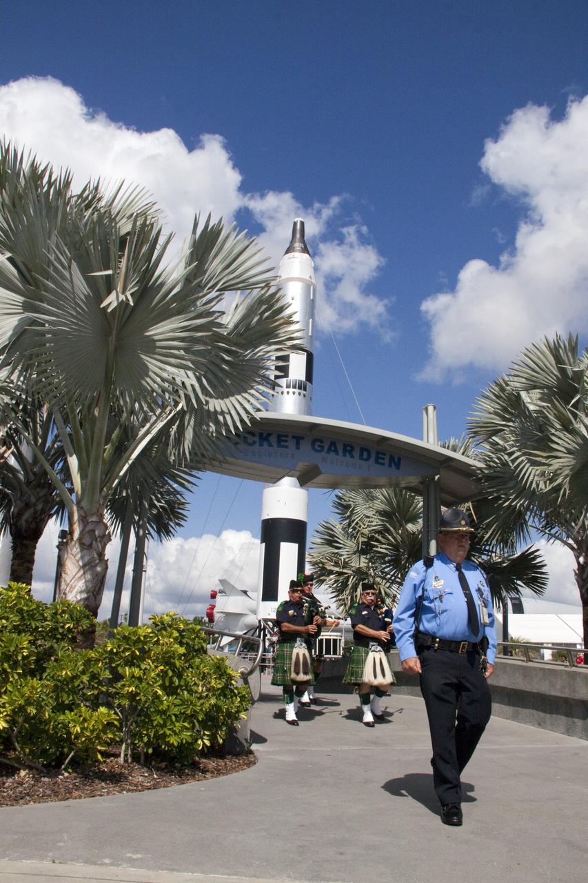 CAPE CANAVERAL, Fla. -- The Miami-Dade Police Department Honor Guard Unit play the bagpipes as they make their way to the Astronaut Memorial Mirror at NASA's Kennedy Space Center Visitor Complex for the U.S. Honor Flag presentation ceremony.       The flag is presented to NASA to be prepared to fly aboard space shuttle Atlantis on the Space Shuttle Program's final mission, STS-135. The U.S. Honor Flag has been flown nationwide, at Ground Zero and throughout the world to honor heroes who have lost their lives while serving their community and country, including police officers, firefighters, members of the Armed Forces and astronauts. More than 100 honor guard members traveled to the Space Coast to take part in the ceremony. After the flag returns to Earth, it will continue as a traveling memorial. Photo credit: NASA/Troy Cryder
