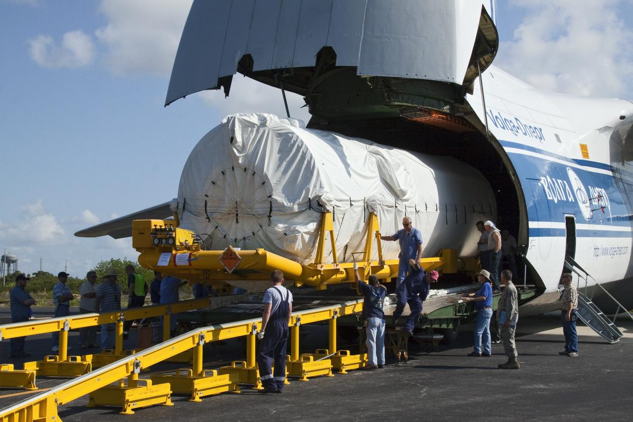 CAPE CANAVERAL, Fla. -- On the Skid Strip at Cape Canaveral Air Force Station in Florida, workers unload the Centaur upper stage of the United Launch Alliance Atlas V rocket slated to launch NASA's Juno spacecraft from a Volga-Dnepr Antonov AN-124-100, a Ukranian/Russian cargo aircraft. NASA's Juno spacecraft is scheduled to launch aboard the Atlas V from Cape Canaveral, Fla. Aug. 5.The solar-powered spacecraft will orbit Jupiter's poles 33 times to find out more about the gas giant's origins, structure, atmosphere and magnetosphere and investigate the existence of a solid planetary core. For more information visit: www.nasa.gov/juno. Photo credit: NASA/Jack Pfaller
