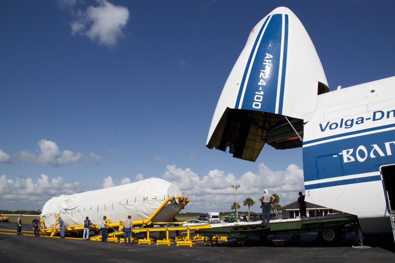 CAPE CANAVERAL, Fla. -- On the Skid Strip at Cape Canaveral Air Force Station in Florida, workers unload the Centaur upper stage of the United Launch Alliance Atlas V rocket slated to launch NASA's Juno spacecraft from a Volga-Dnepr Antonov AN-124-100, a Ukranian/Russian cargo aircraft.            NASA's Juno spacecraft is scheduled to launch aboard the Atlas V from Cape Canaveral, Fla. Aug. 5.The solar-powered spacecraft will orbit Jupiter's poles 33 times to find out more about the gas giant's origins, structure, atmosphere and magnetosphere and investigate the existence of a solid planetary core. For more information visit: www.nasa.gov/juno. Photo credit: NASA/Jack Pfaller