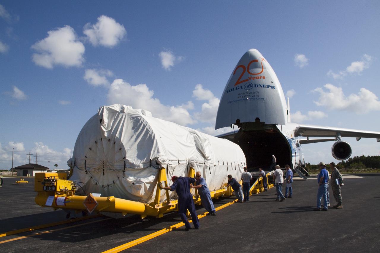 CAPE CANAVERAL, Fla. -- On the Skid Strip at Cape Canaveral Air Force Station in Florida, workers unload the Centaur upper stage of the United Launch Alliance Atlas V rocket slated to launch NASA's Juno spacecraft from a Volga-Dnepr Antonov AN-124-100, a Ukranian/Russian cargo aircraft.            NASA's Juno spacecraft is scheduled to launch aboard the Atlas V from Cape Canaveral, Fla. Aug. 5.The solar-powered spacecraft will orbit Jupiter's poles 33 times to find out more about the gas giant's origins, structure, atmosphere and magnetosphere and investigate the existence of a solid planetary core. For more information visit: www.nasa.gov/juno. Photo credit: NASA/Jack Pfaller