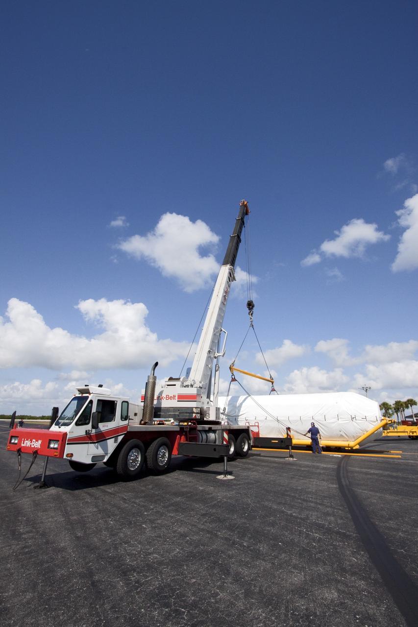 CAPE CANAVERAL, Fla. -- On the Skid Strip at Cape Canaveral Air Force Station in Florida, workers  attach a crane to lift the Centaur upper stage of the United Launch Alliance Atlas V rocket slated to launch NASA's Juno spacecraft onto a transporter.          NASA's Juno spacecraft is scheduled to launch aboard the Atlas V from Cape Canaveral, Fla. Aug. 5.The solar-powered spacecraft will orbit Jupiter's poles 33 times to find out more about the gas giant's origins, structure, atmosphere and magnetosphere and investigate the existence of a solid planetary core. For more information visit: www.nasa.gov/juno. Photo credit: NASA/Jack Pfaller