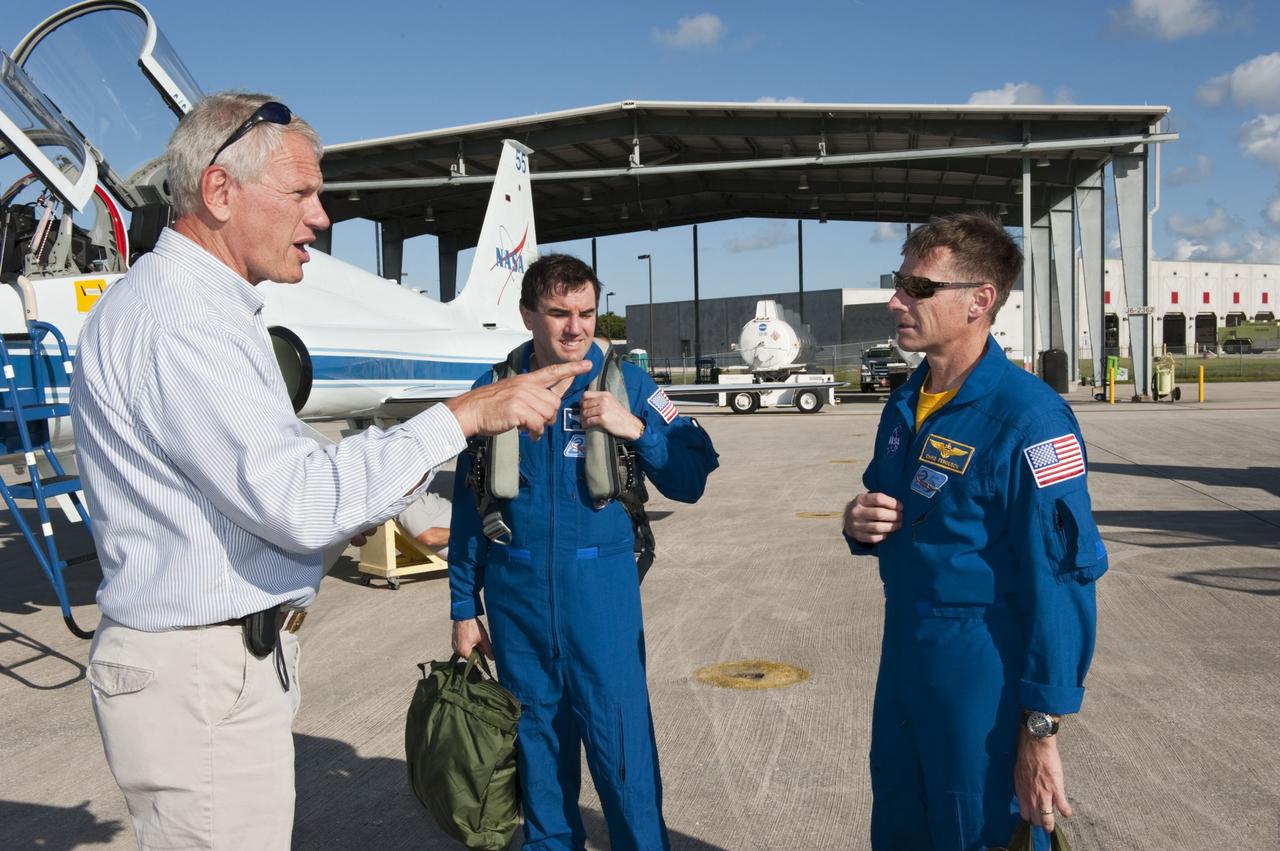 CAPE CANAVERAL, Fla. -- United Space Allaince's Matt Gaetjens with the Astronaut Support Office, left, greets STS-135 Mission Specialist Rex Walheim and Commander Chris Ferguson on the Shuttle Landing Facility at NASA's Kennedy Space Center in Florida. The flight crew of four arrived aboard T-38 training jets to watch two historic milestones of NASA's Space Shuttle Program -- the final landing of shuttle Endeavour, which will bookend its STS-134 mission to the International Space Station, and the final rollout of their vehicle, space shuttle Atlantis, to Launch Pad 39A.         STS-135 will be the 33rd flight of Atlantis, the 37th shuttle mission to the space station, and the 135th and final mission of the shuttle program. For more information visit, www.nasa.gov/mission_pages/shuttle/shuttlemissions/sts135/index.html. Photo credit: NASA/Kim Shiflett